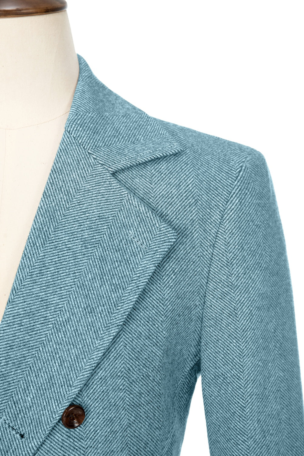 Light blue close-up of lapel detail on double-breasted wool coat