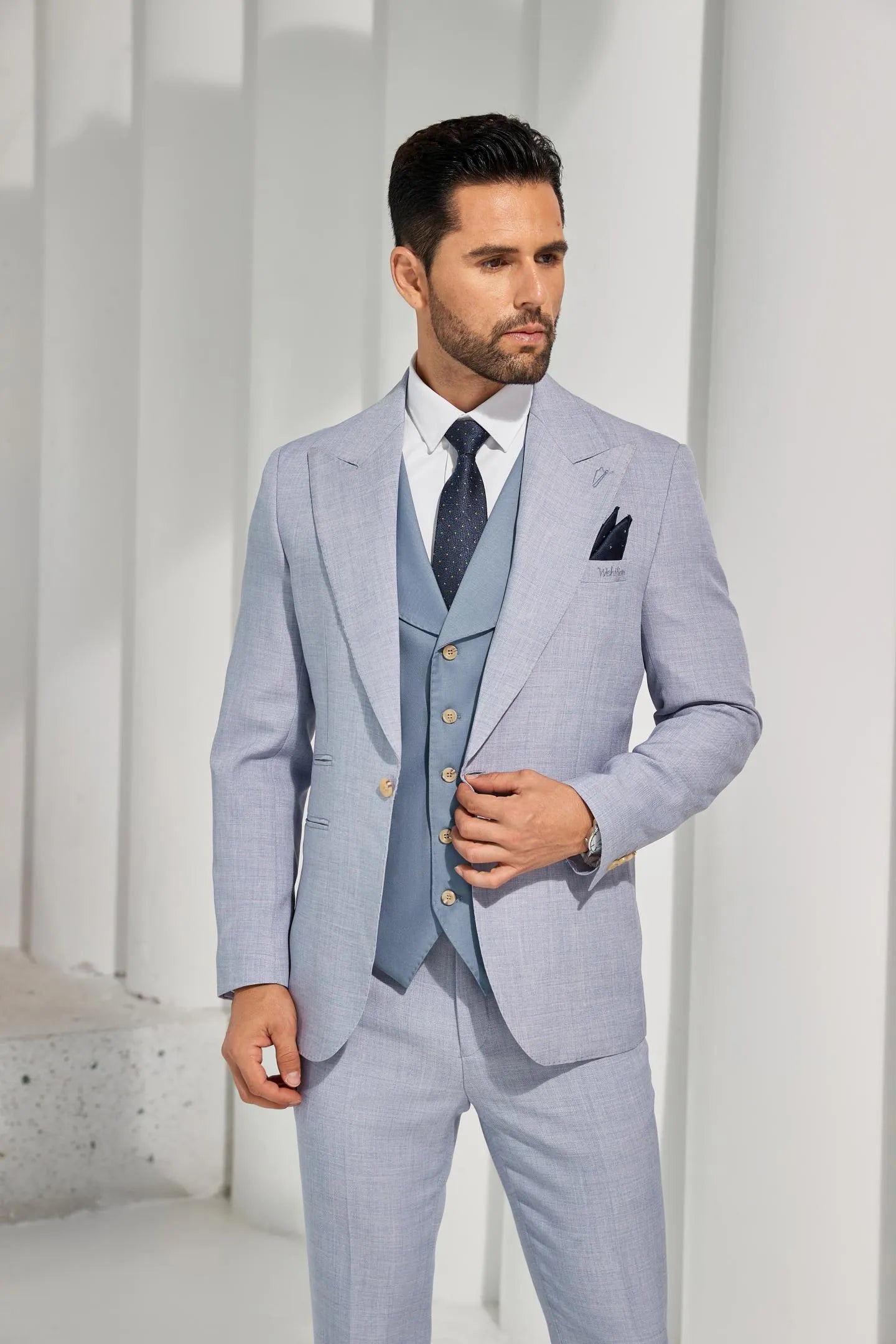 close-up of men's light blue summer suit with a notch lapel, paired with a coordinating tie, perfect for casual outings.