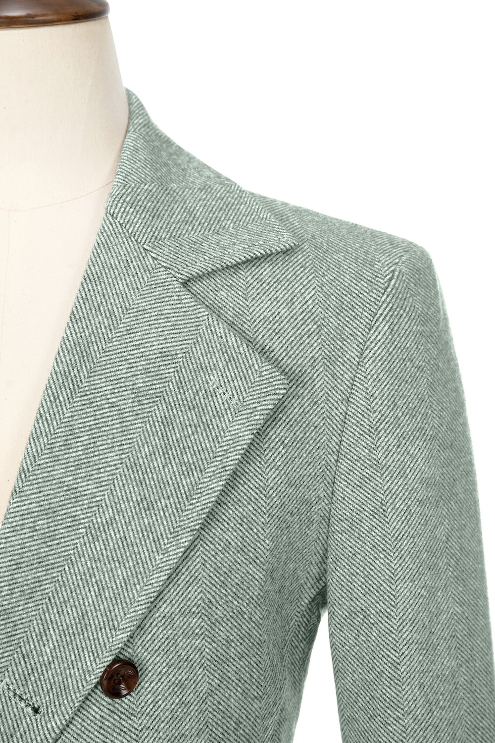 Light green close-up of lapel detail on double-breasted wool coat