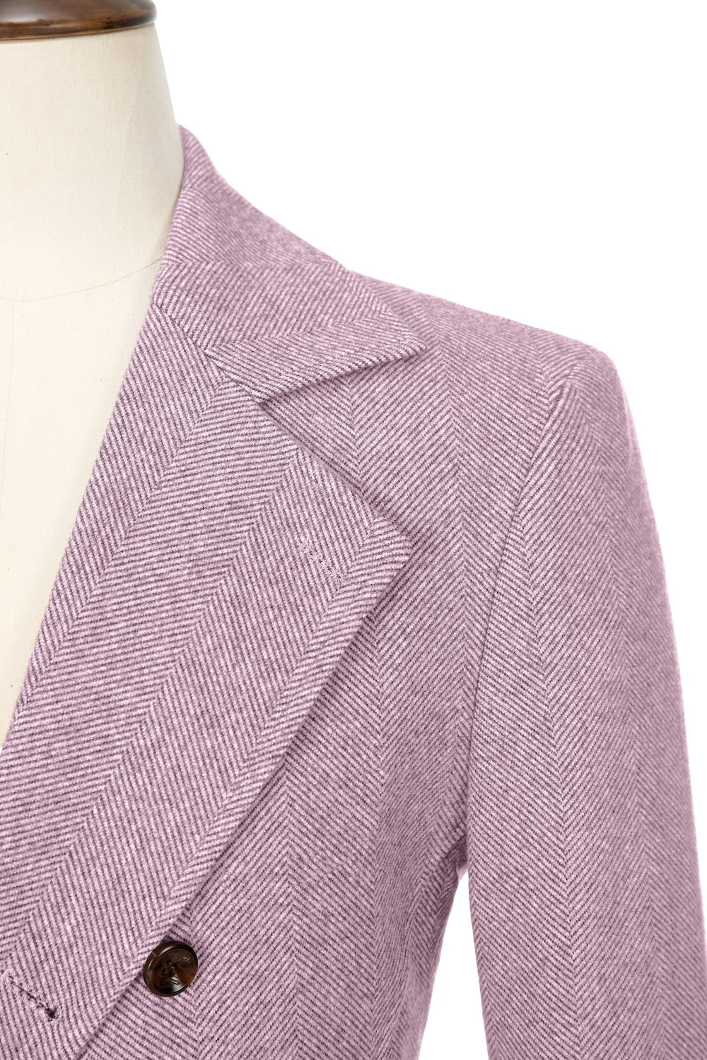 Light pink close-up of lapel detail on double-breasted wool coat