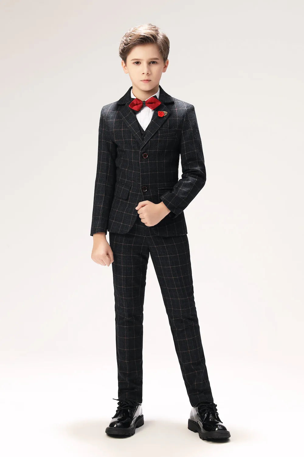 Slim fit black plaid boys suit with red bow tie, formal 5 piece outfit perfect for weddings or parties