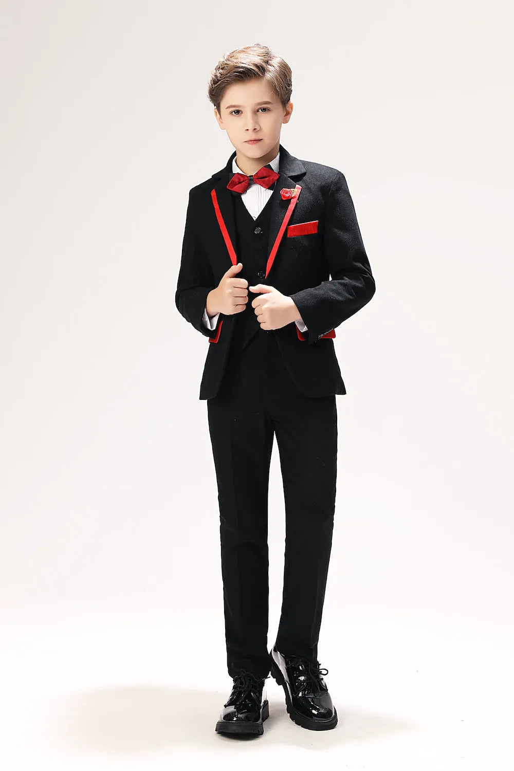 Boys' prom suits 5-piece black formal suit with red trim, red bow tie, and shiny dress shoes, front full view
