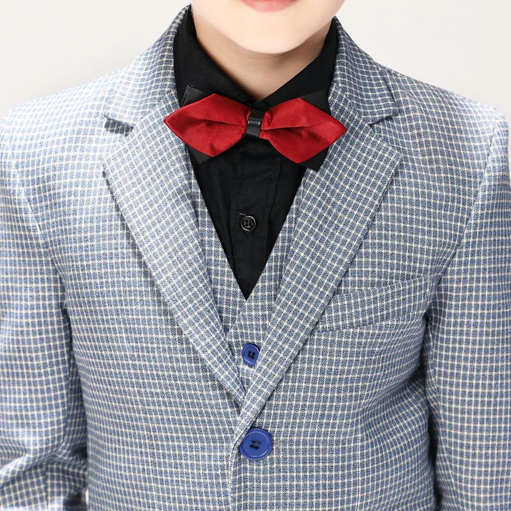 Close-up of red bow tie and black shirt styled under boys' plaid formal blazer