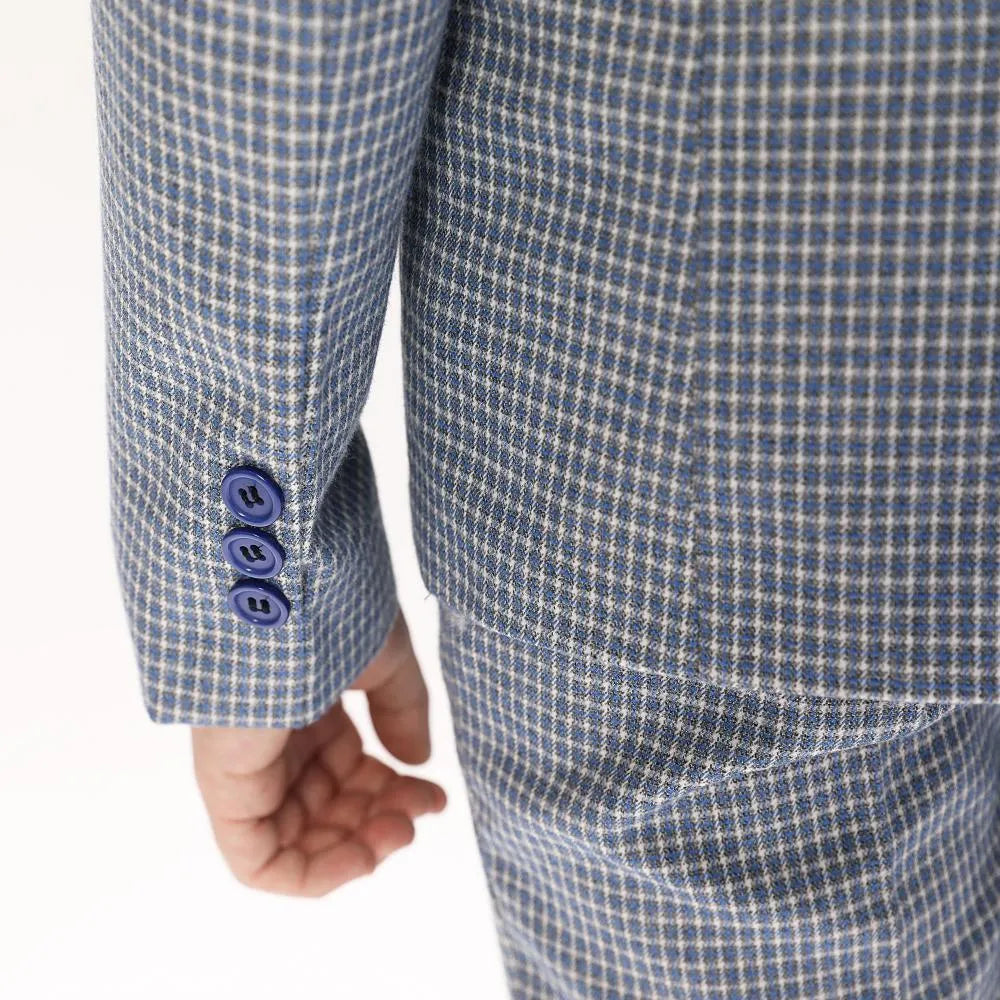 Close-up of sleeve buttons on boys' black and white plaid formal blazer