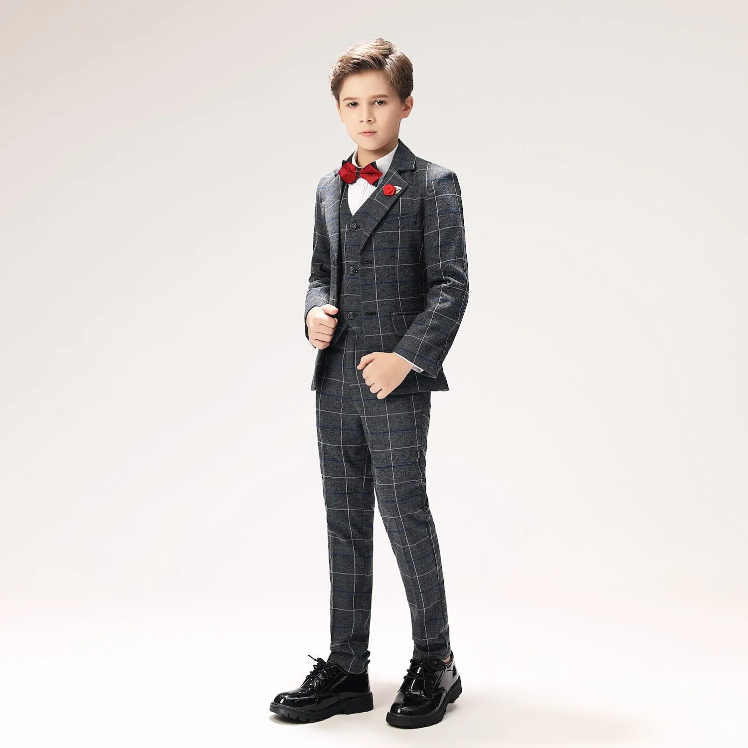 Elegant checked boys suit in dark grey with white shirt and red accessories