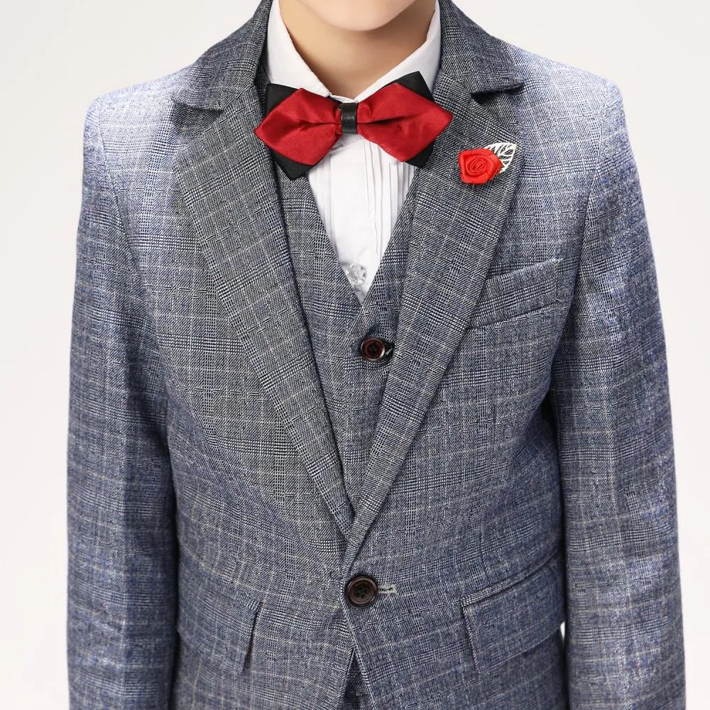 Close-up of boys plaid suit blazer with classic notch lapel and red formal rose pin accessory