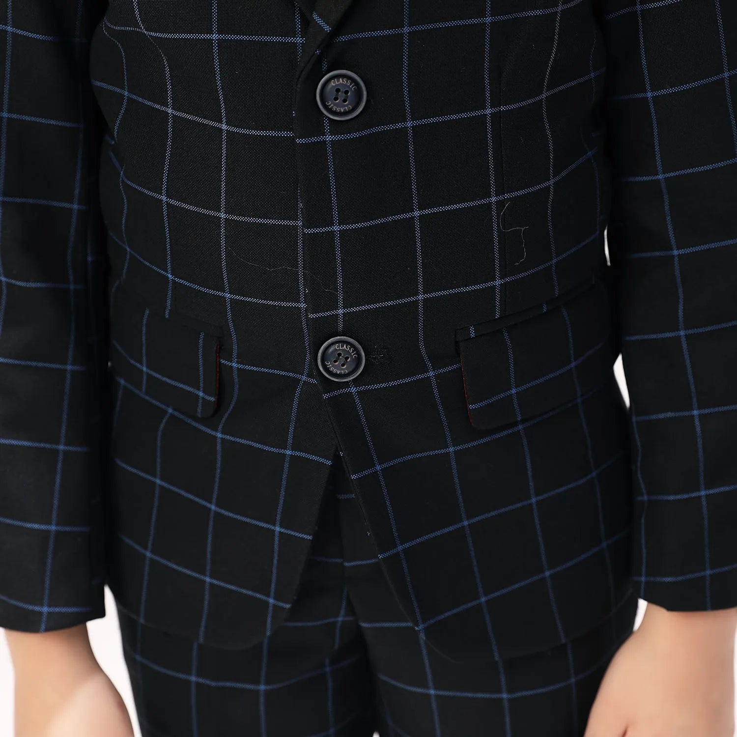 Button and pocket detail on navy plaid boys blazer, elegant formal outfit for kids