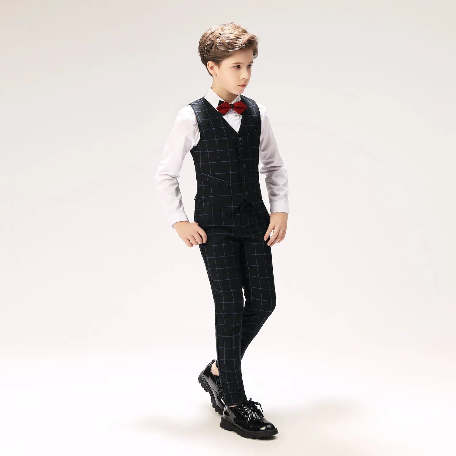 Little boy in navy checkered formal suit holding rose, ideal for ring bearer look