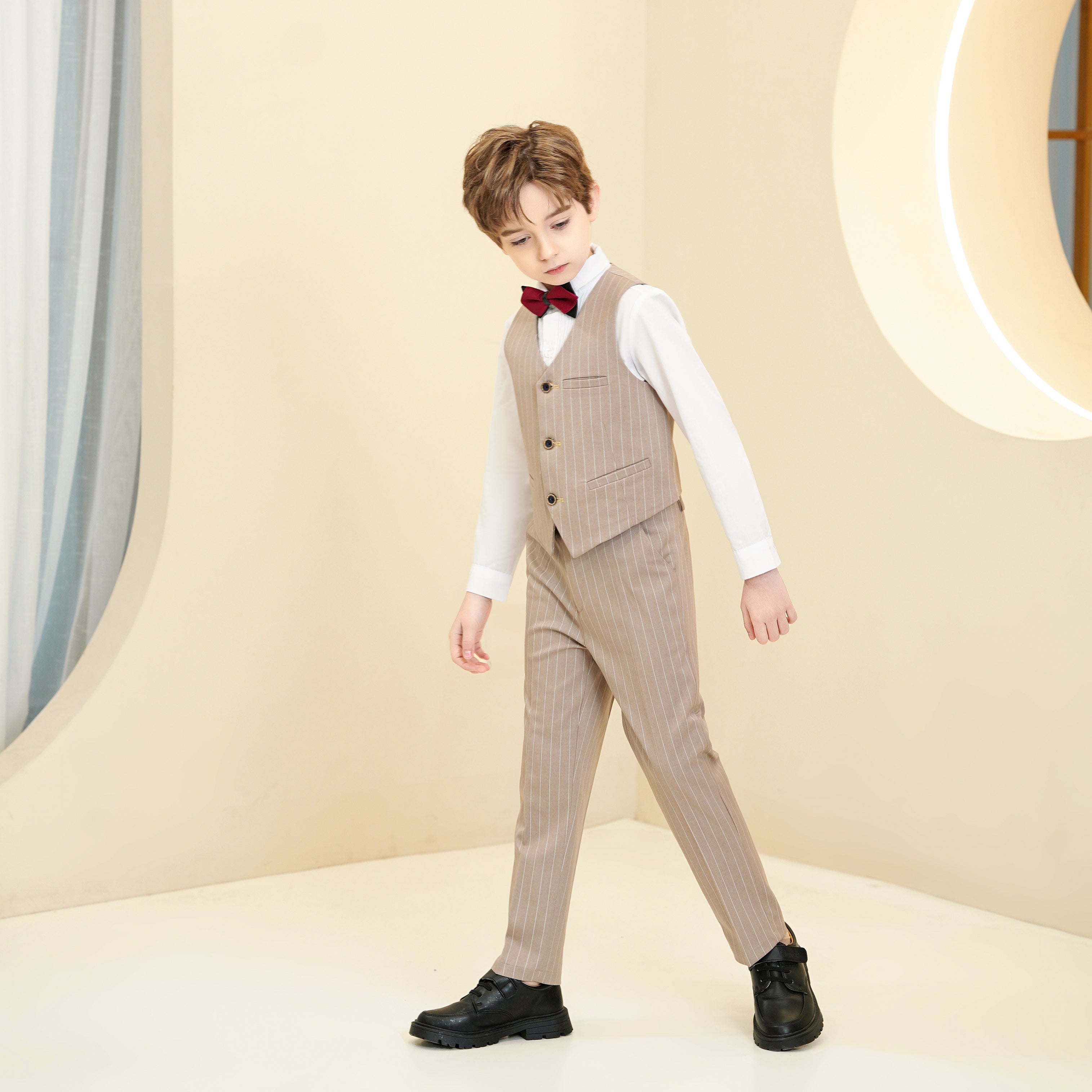 Side walking pose in khaki striped boys suit – charming and breathable party look