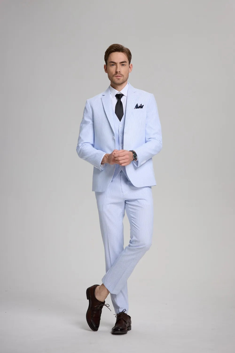 Full-body front view of blue seersucker 3-piece suit with white shirt and black tie