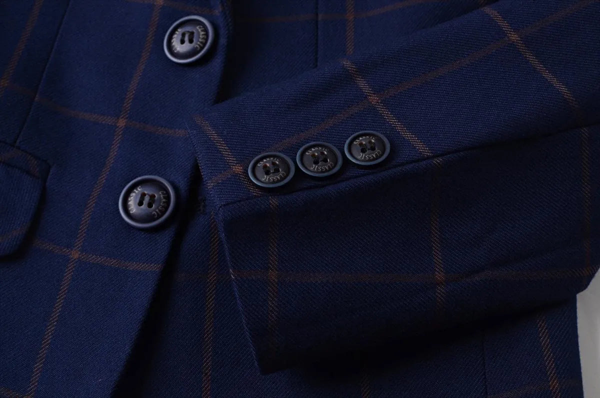 Close-up of sleeve buttons on boys plaid blazer with check pattern