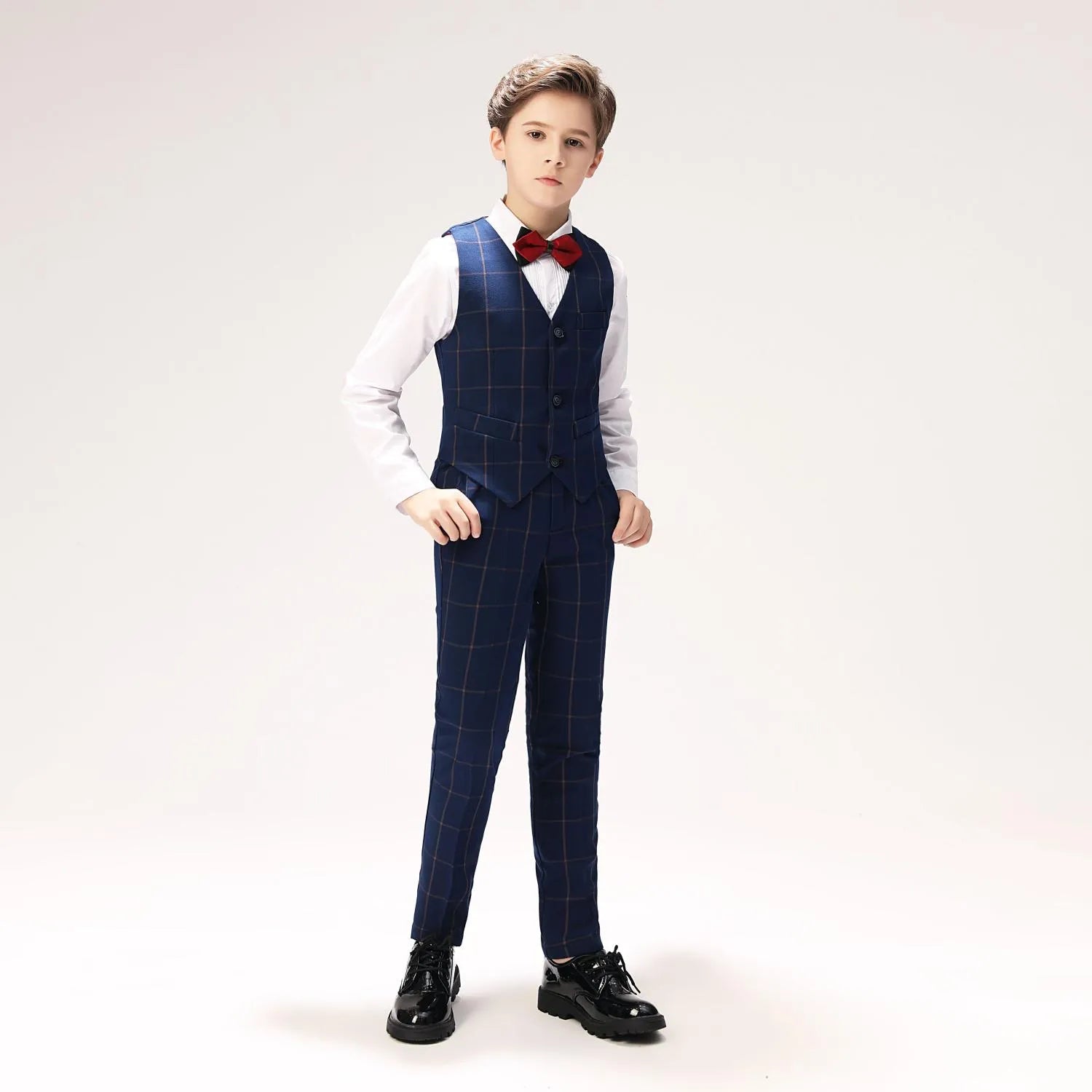 Boy in navy checkered vest set holding an ice cream, casual formal look