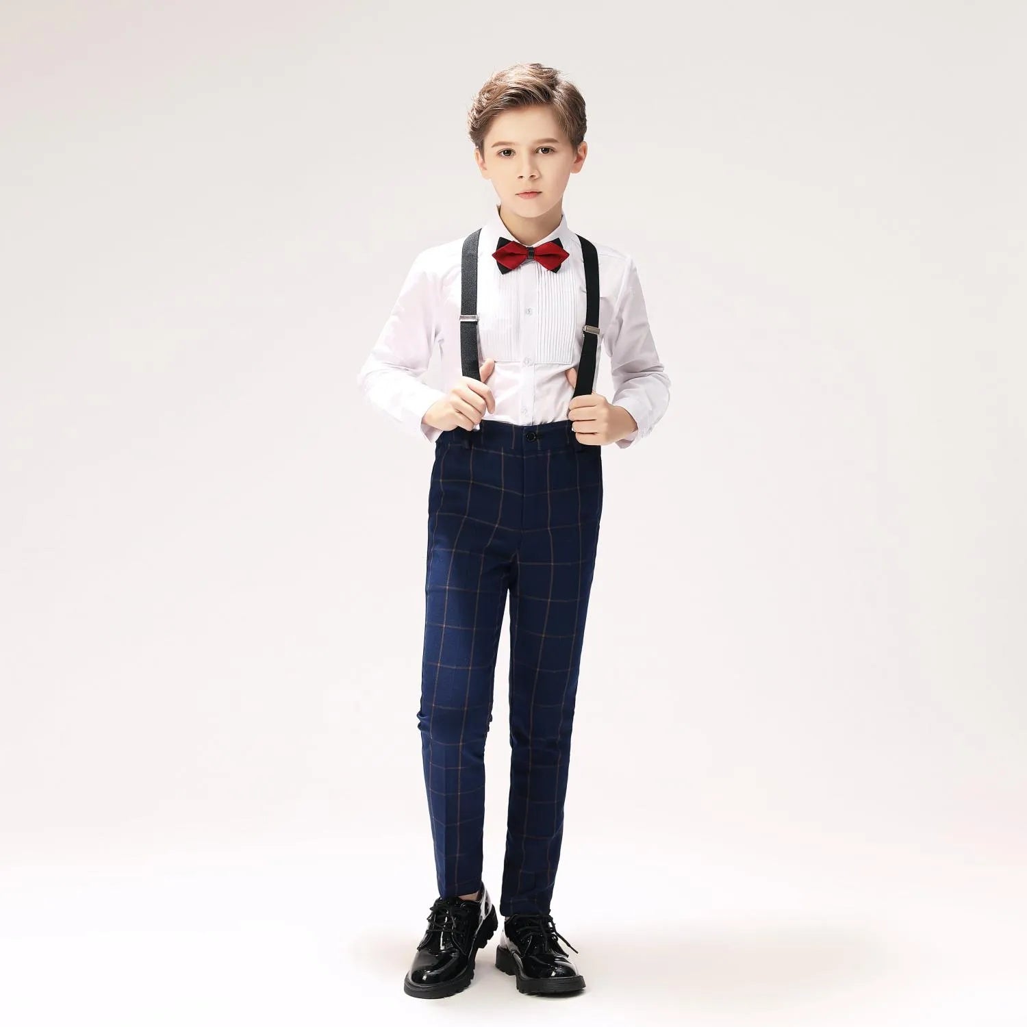 White shirt and suspenders paired with boys navy plaid pants outfit
