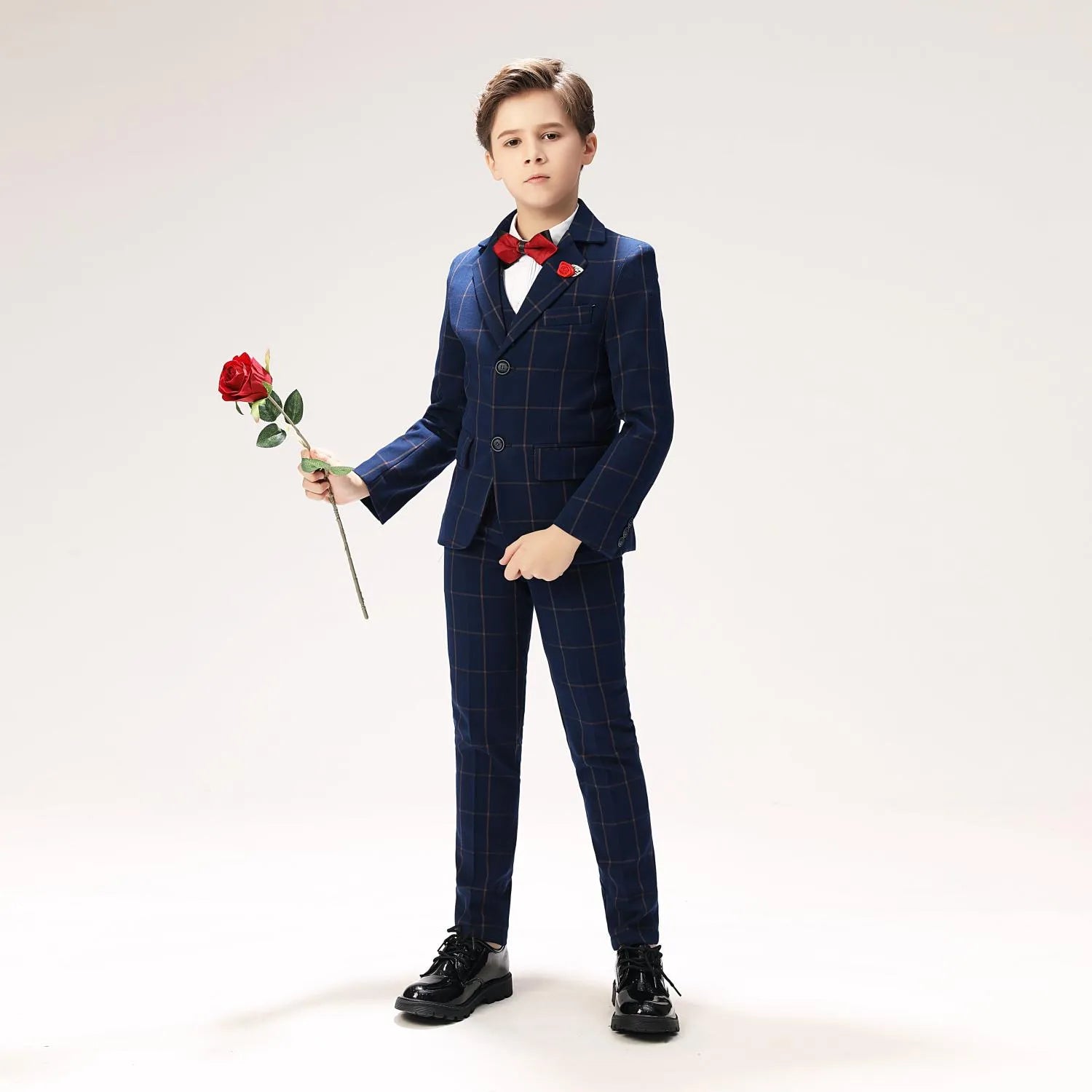 Elegant boys blue windowpane check suit with red rose lapel pin