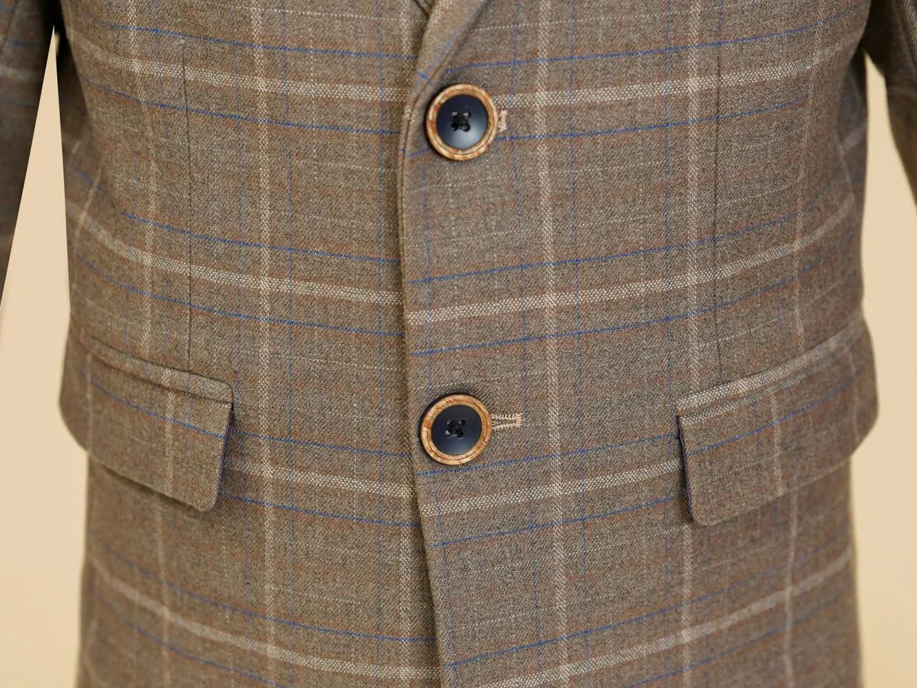 Khaki plaid boys suit: Close-up of button & checked blazer front detail