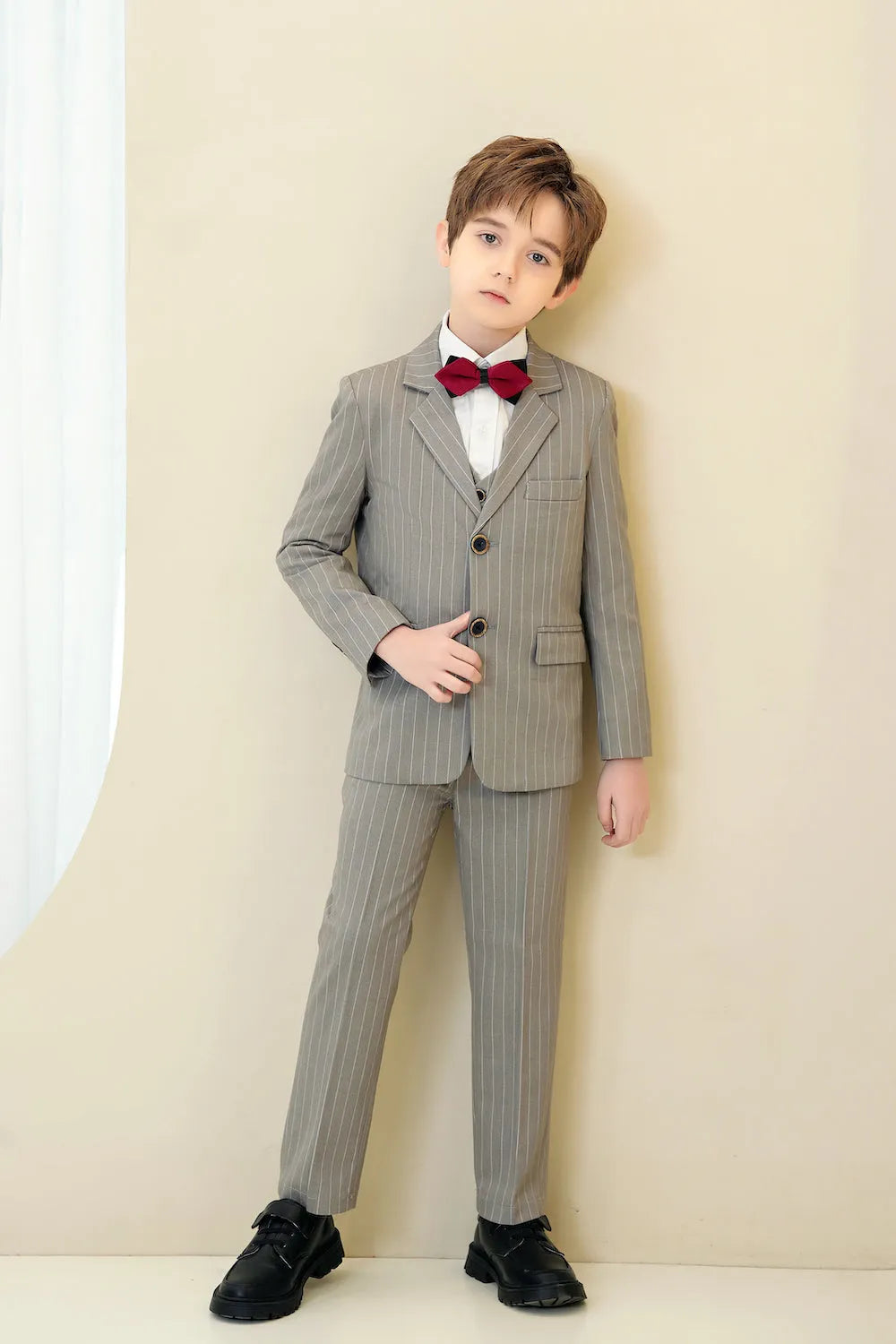 Light grey striped 5-piece boys formal suit with red bow tie and notch lapel jacket