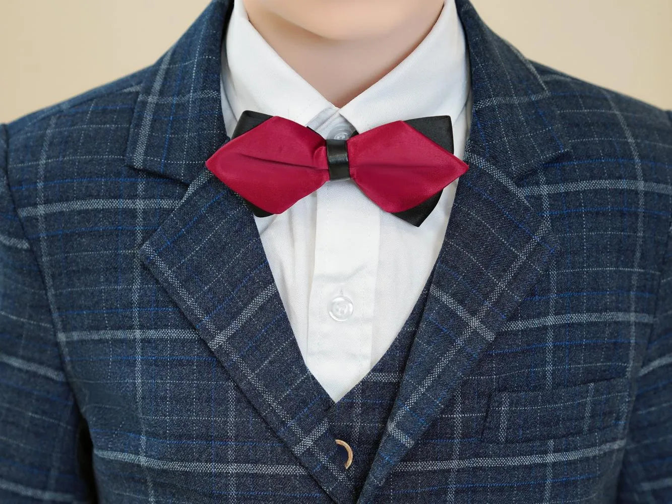 Navy check boys formal suit: Close-up of red bow tie & plaid lapel detail