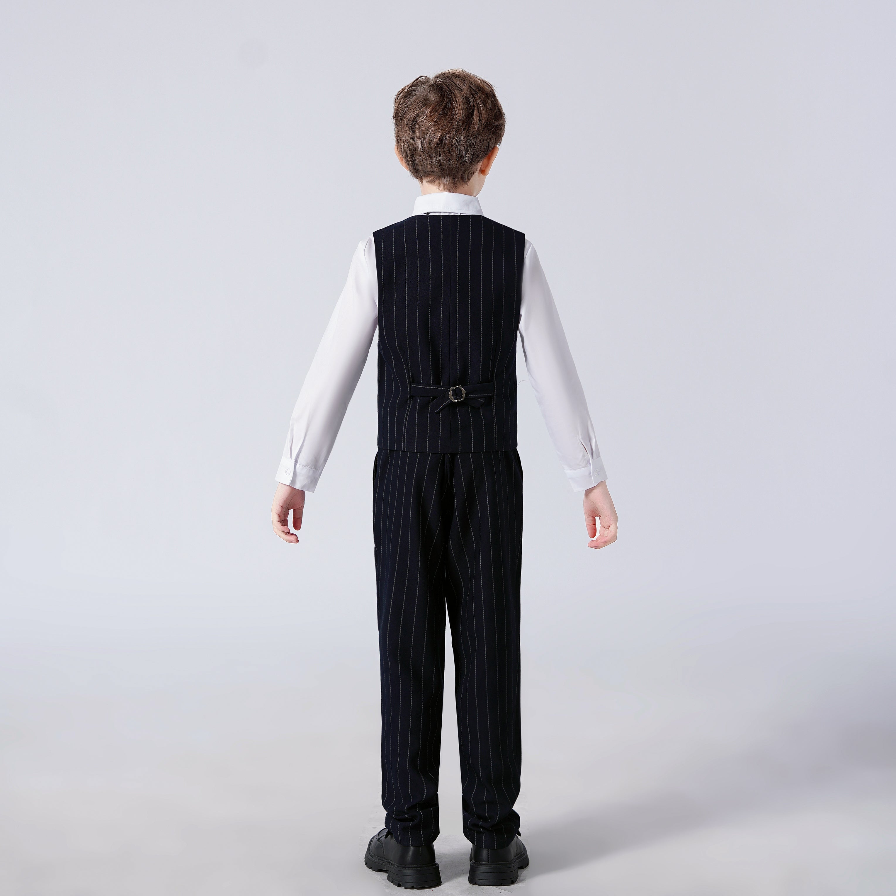 Back view of black striped modern 4-piece boys' formal suit: Pinstripe vest, pants & white shirt for weddings, proms