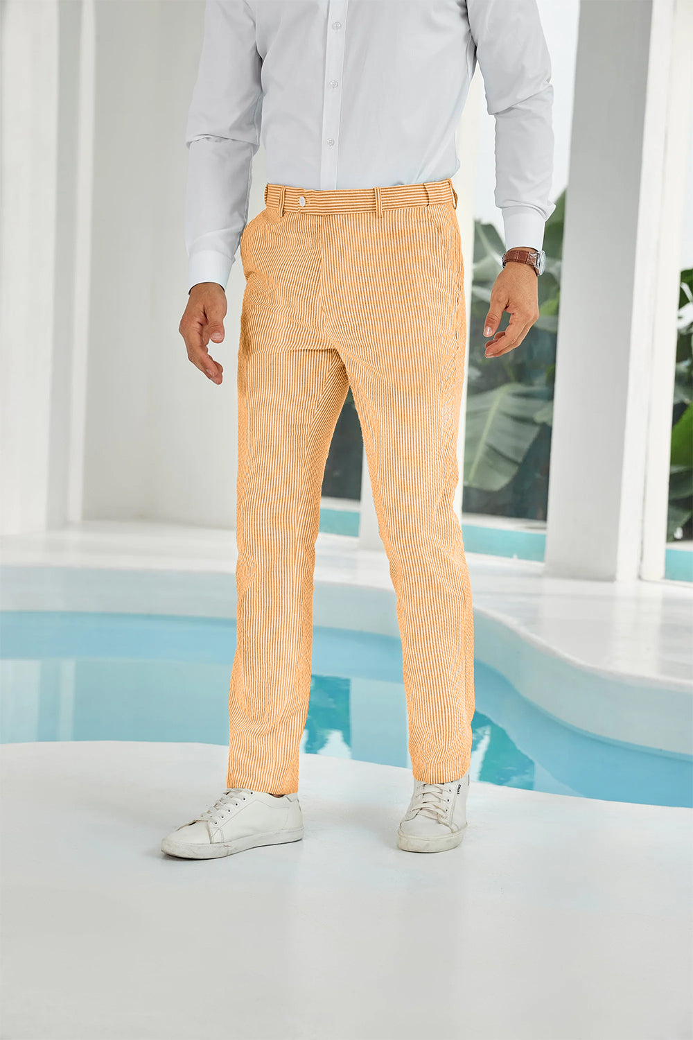 Front view of orange seersucker pants with subtle stripes and white shirt