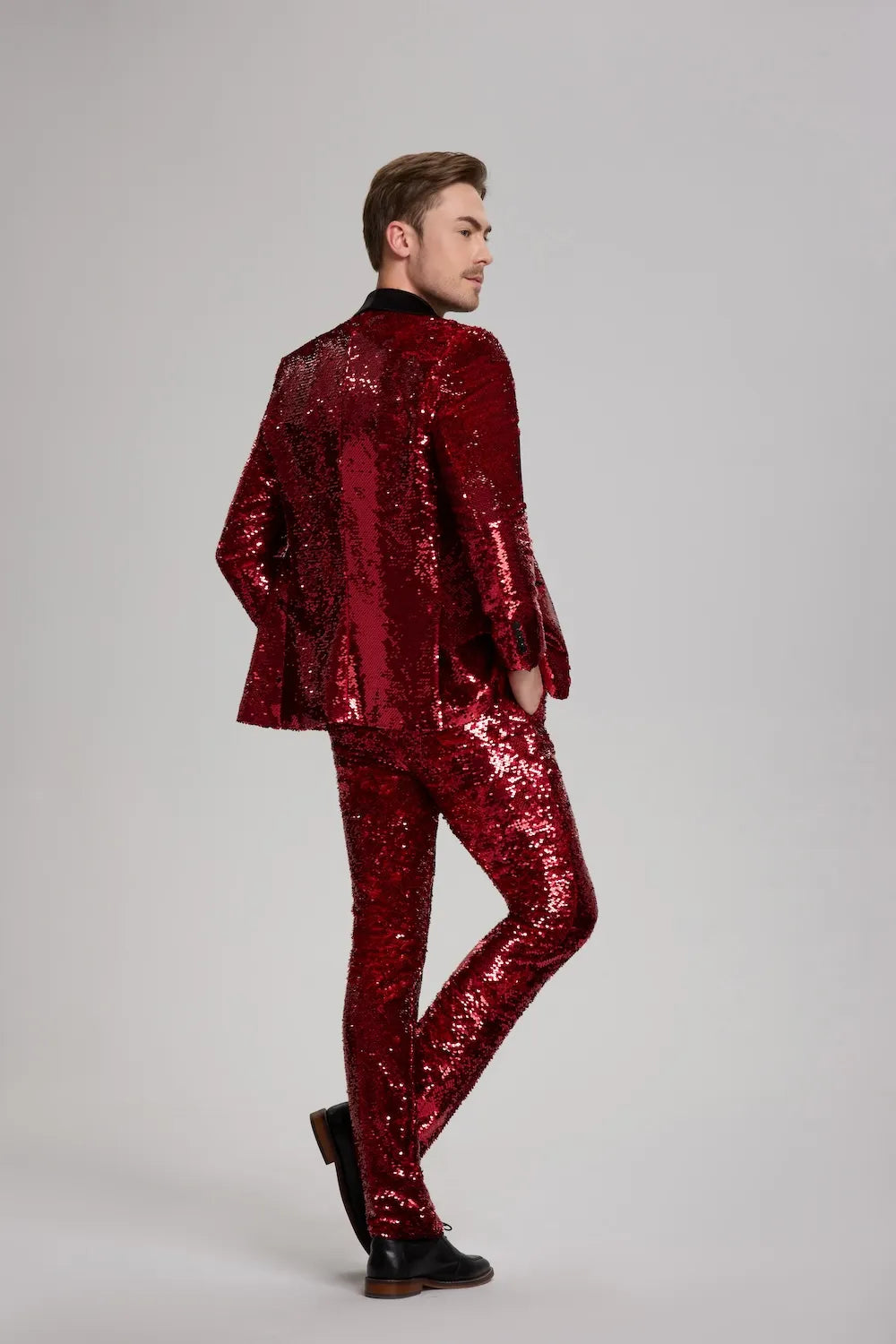 Rear view of men's 3-piece red glitter tuxedo suit, perfect for stage performances and weddings.