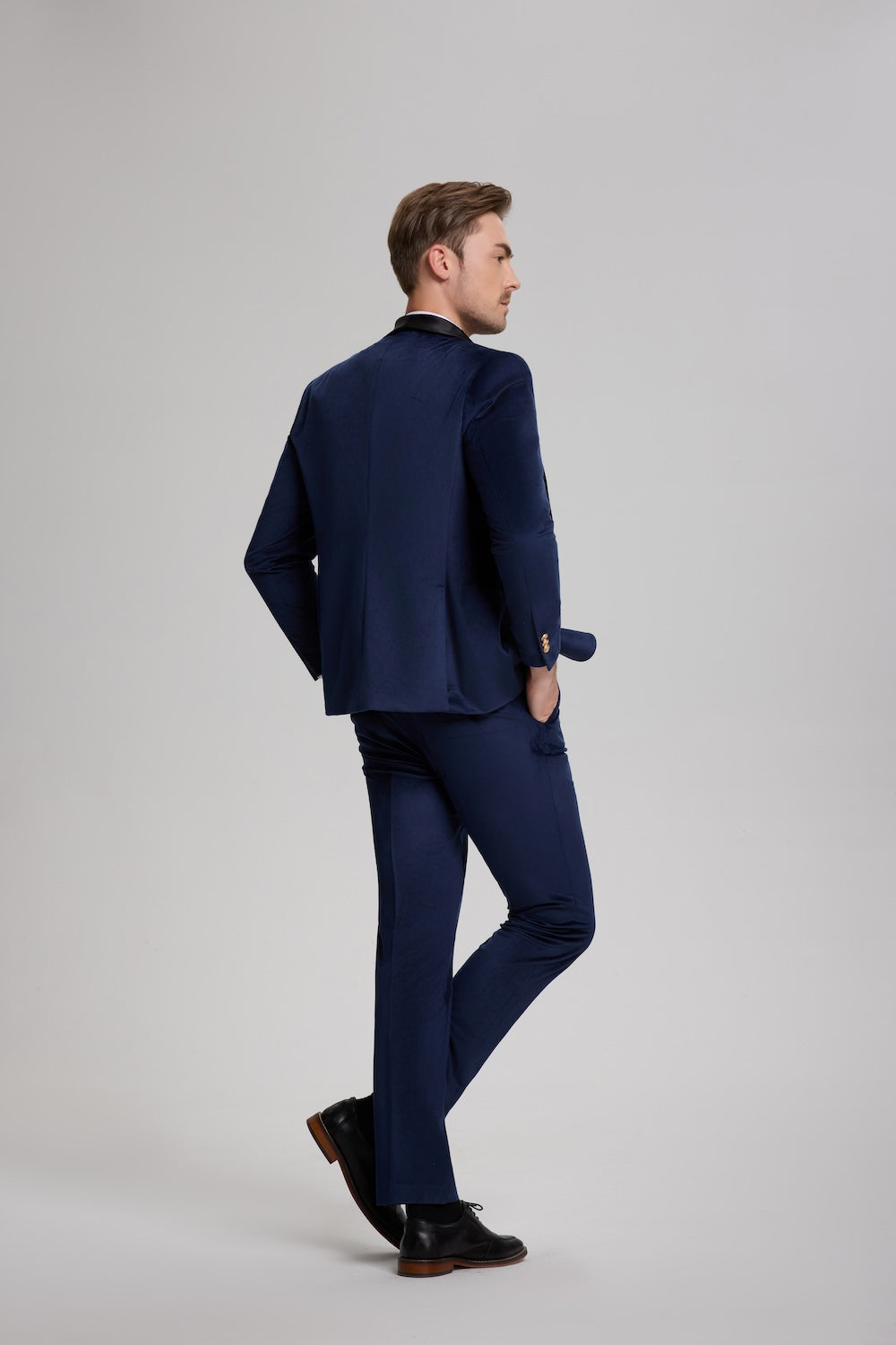 Back view of royal blue velvet men's suit showing elegant tailoring and sheen finish