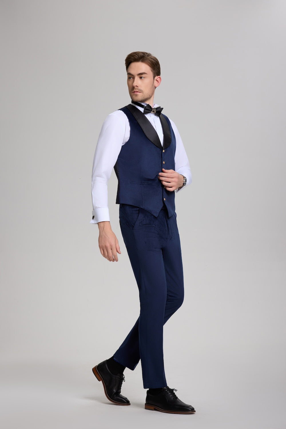 Profile view of royal blue men's formal outfit with satin lapel vest and tailored pants