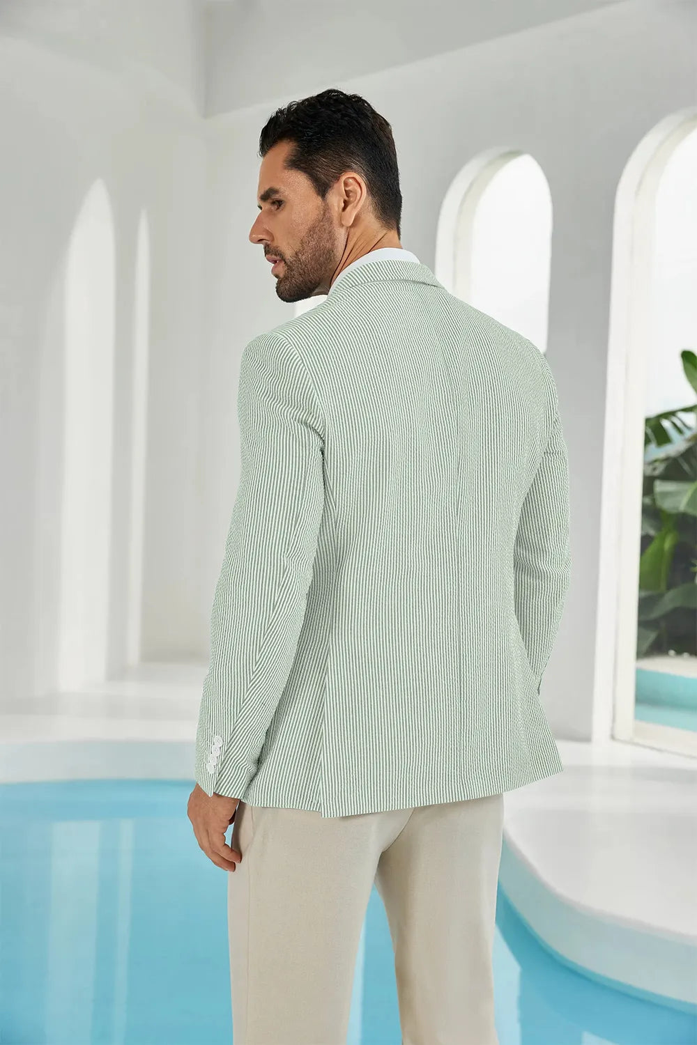 Back view of a sage green and white striped men’s seersucker blazer, ideal for warm-weather occasions.