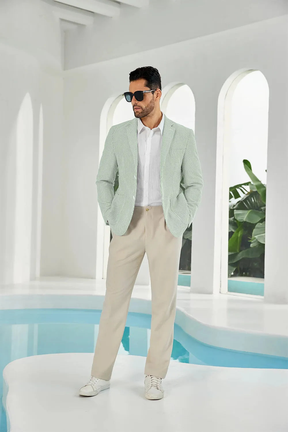 Close-up of a sage green and white striped seersucker blazer, offering a stylish summer look for men.