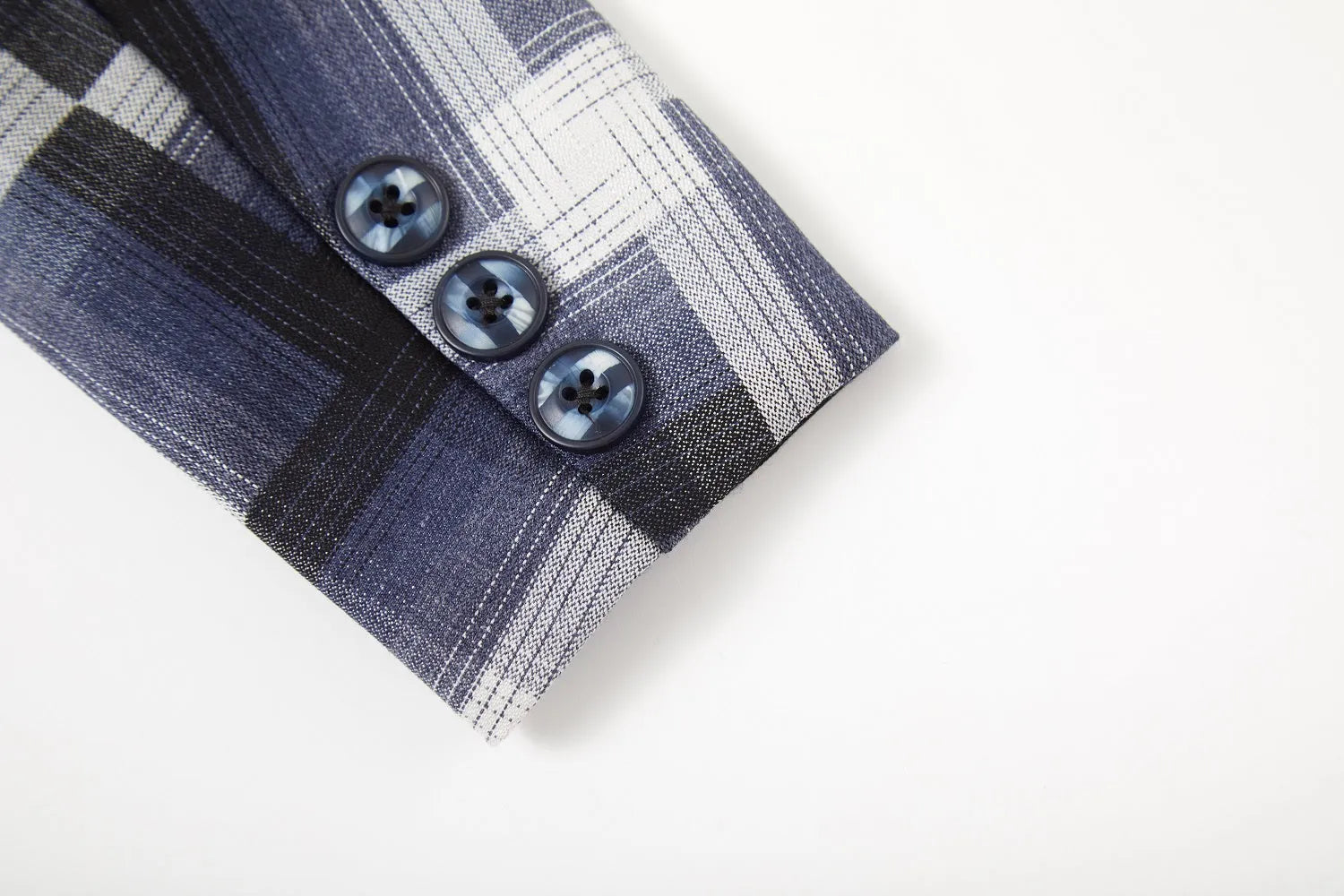 Close-up of boys plaid blazer cuff with navy buttons – stylish detailing on banquet suit sleeve