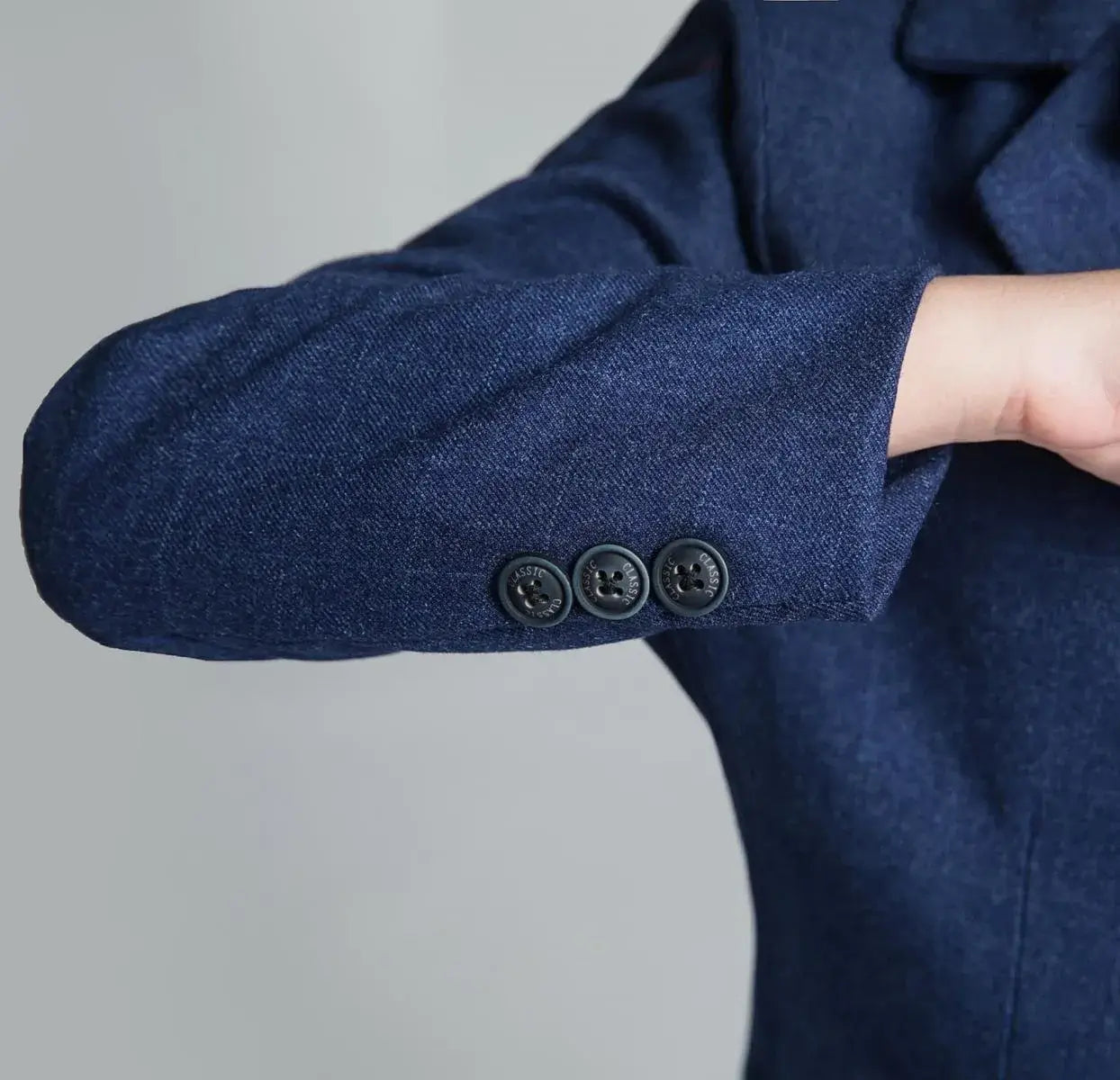 Sleeve button detail of boys navy plaid blazer – tailored style suit for weddings and parties