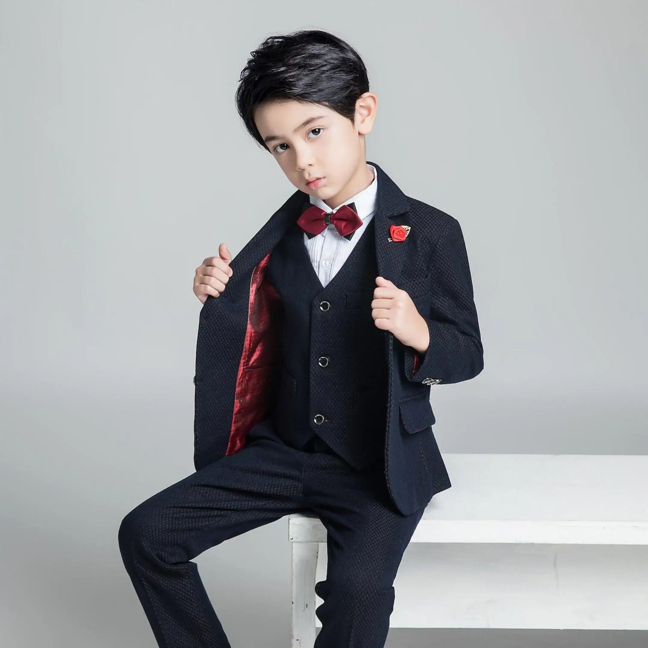 Stylish boys' formal navy suit with red lining and vest, slim fit outfit with bow tie for holiday parties or weddings