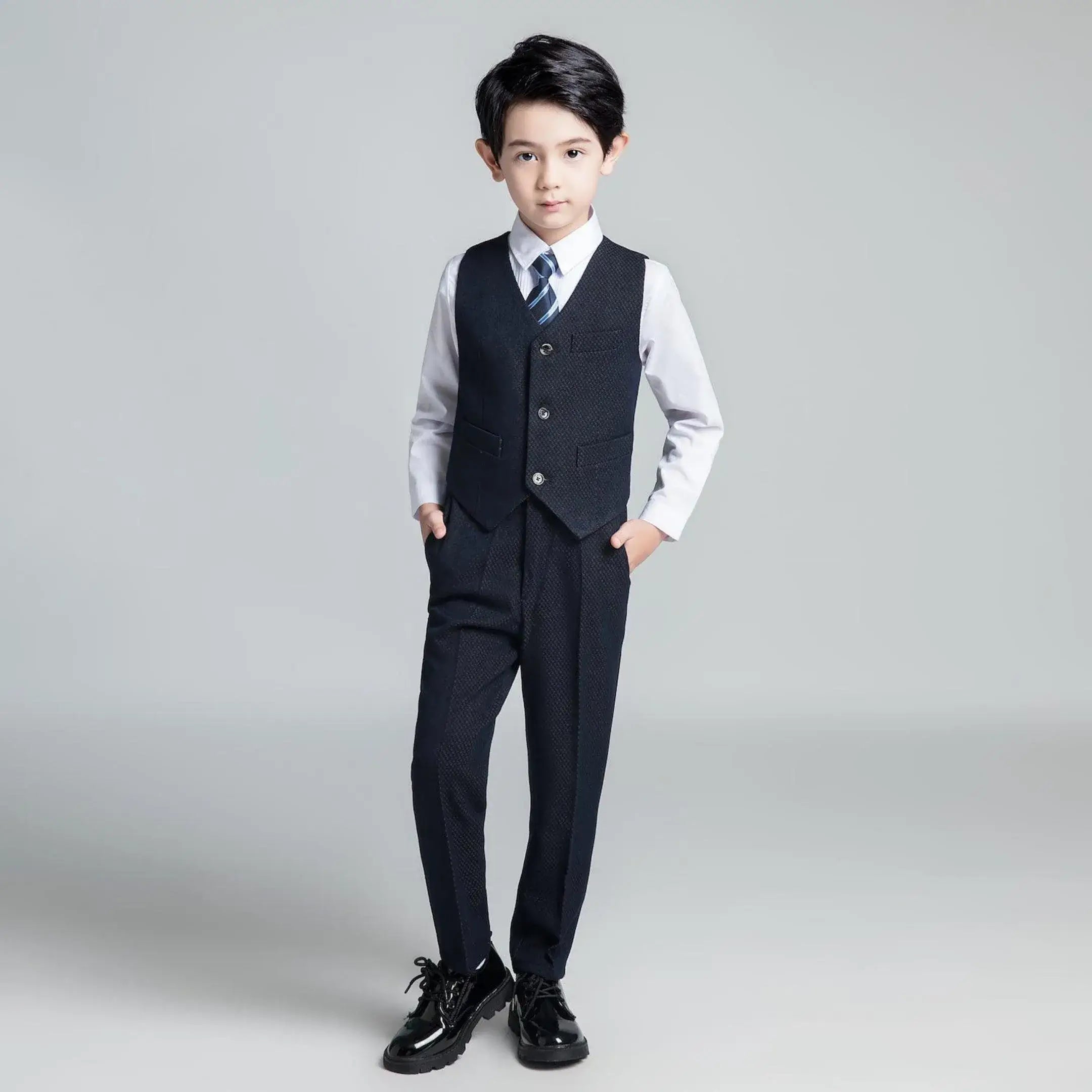 Modern navy boys' vest suit with textured fabric and striped tie, elegant slim fit outfit for formal holiday occasions