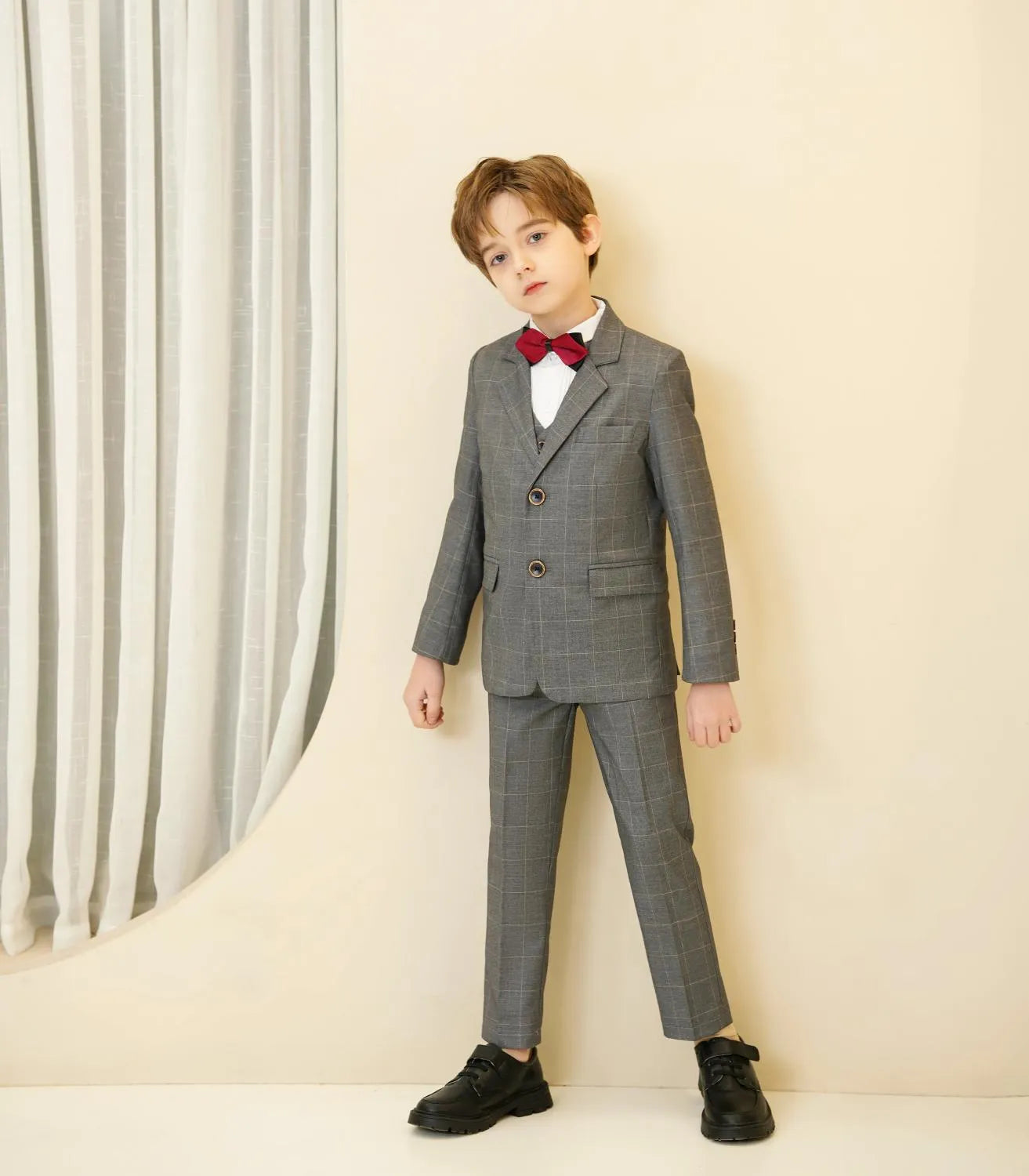 Grey plaid boys 5-piece suit: Side pose with red bow tie for holiday & party