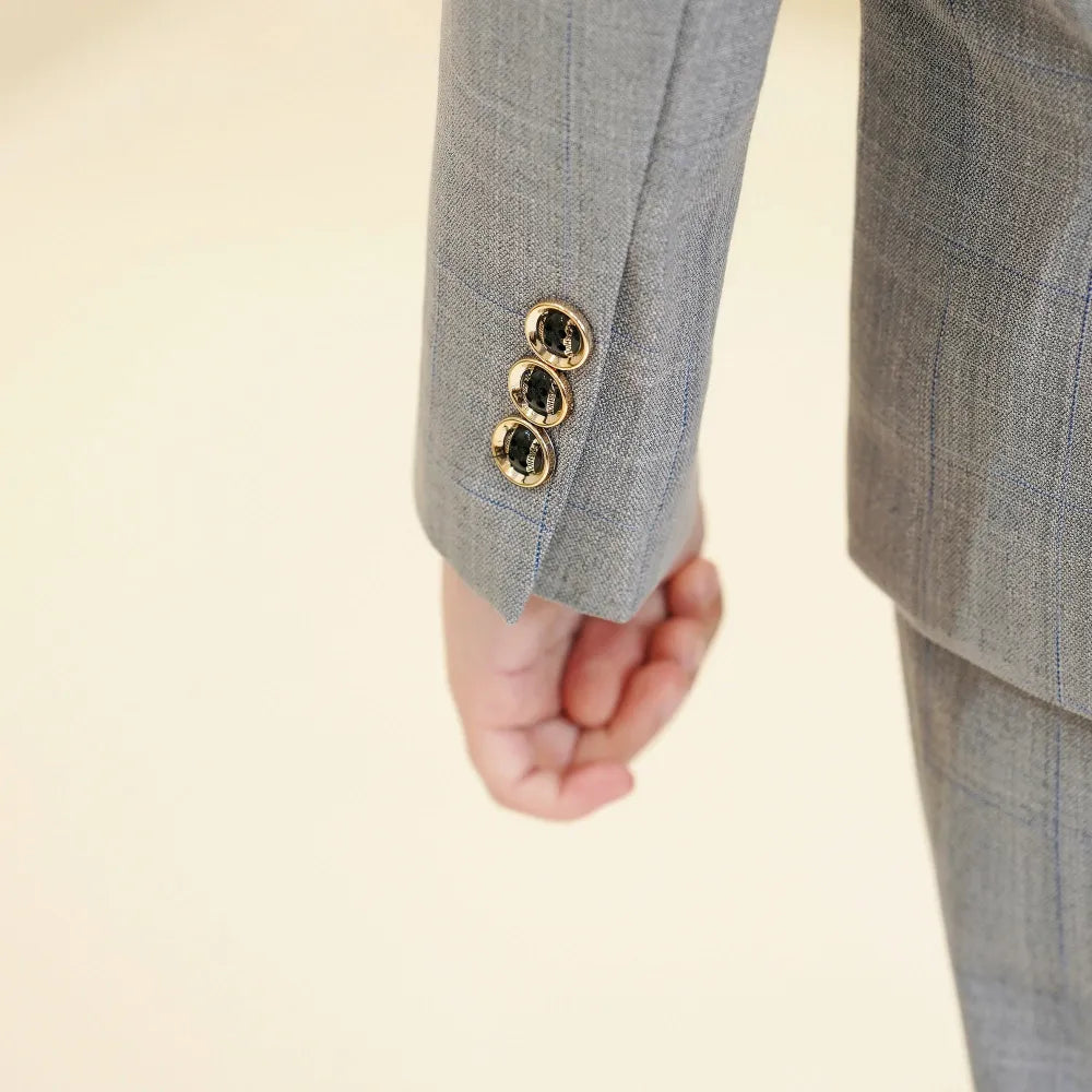 Light grey plaid boys suit: Close-up of gold-trimmed cuff buttons & checked sleeve
