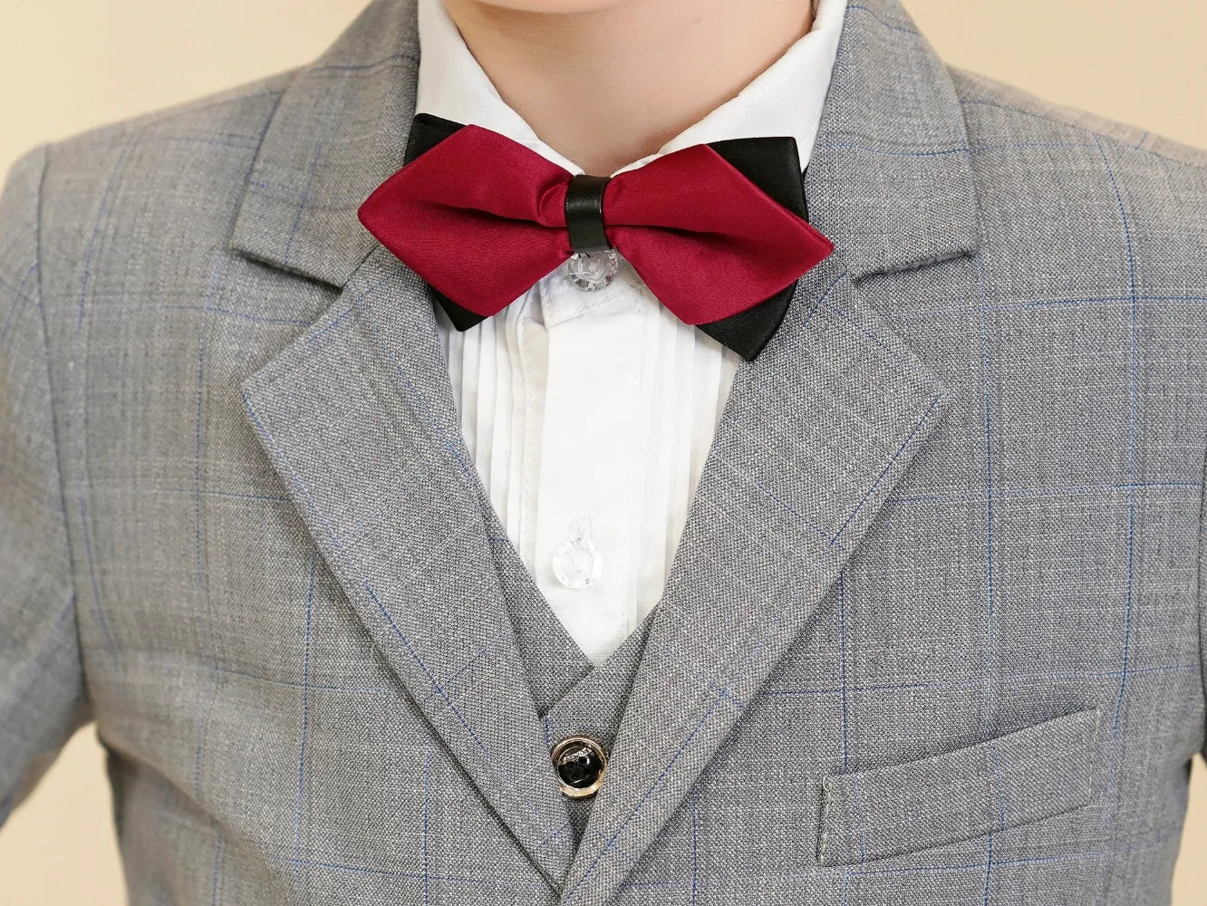 Light grey plaid boys suit: Close-up of red bow tie & checked collar detail