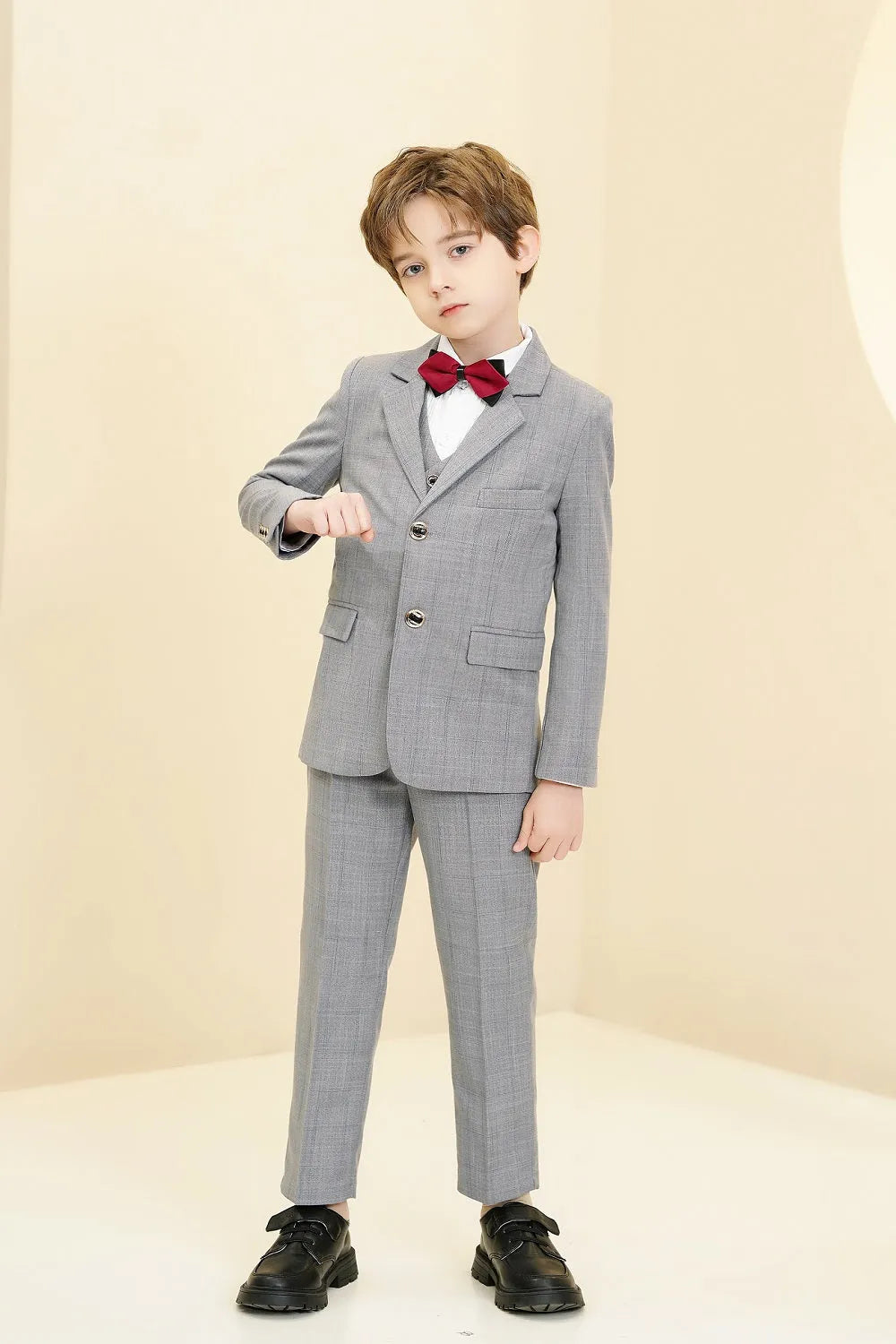 Light grey plaid boys 5-piece suit: Side pose with red bow tie & button detail