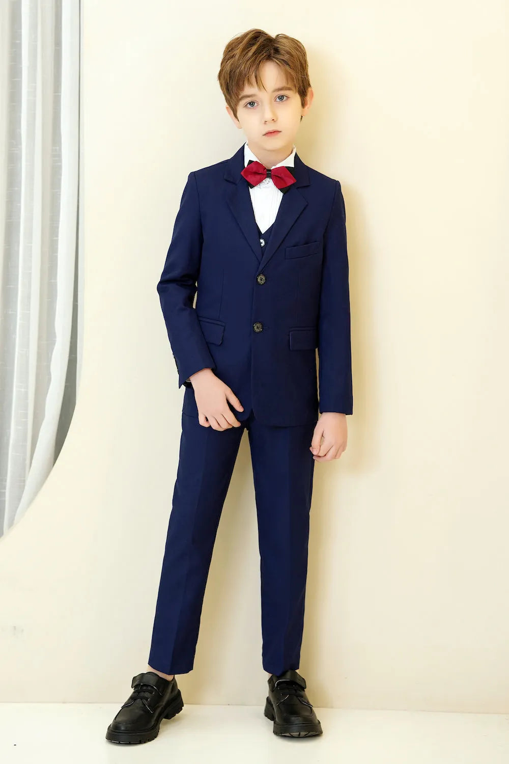 Navy boys' 5-piece formal suit with blazer, vest, pants, white shirt and red bowtie, ideal for weddings and special events