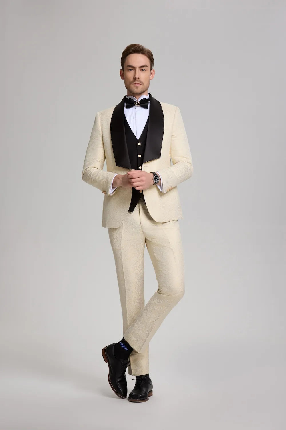 Men's white and gold 3-piece tuxedo suit featuring a black shawl collar jacket and gold buttons.