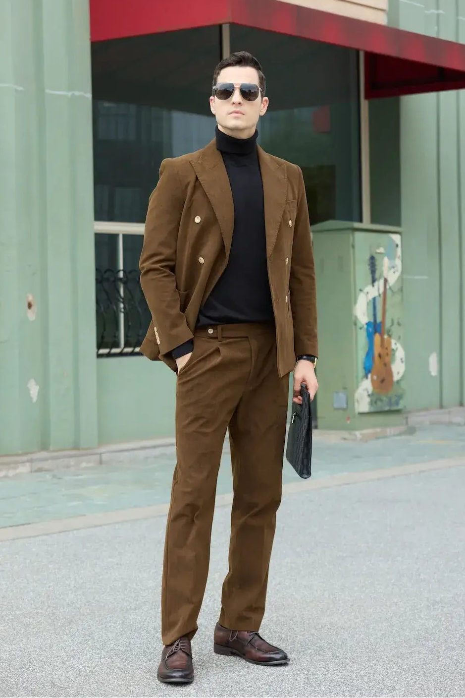 Coffee brown corduroy suit for men – holding black clutch in 2 piece retro fall blazer pants set