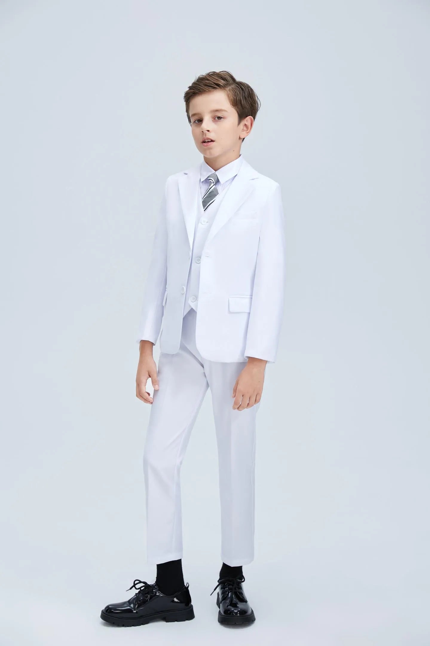 White boys' tuxedo with striped tie and matching vest
