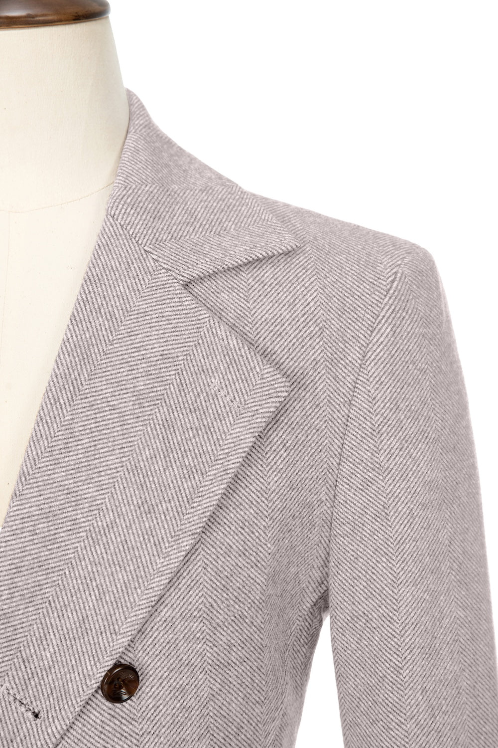 White close-up of lapel detail on double-breasted wool coat