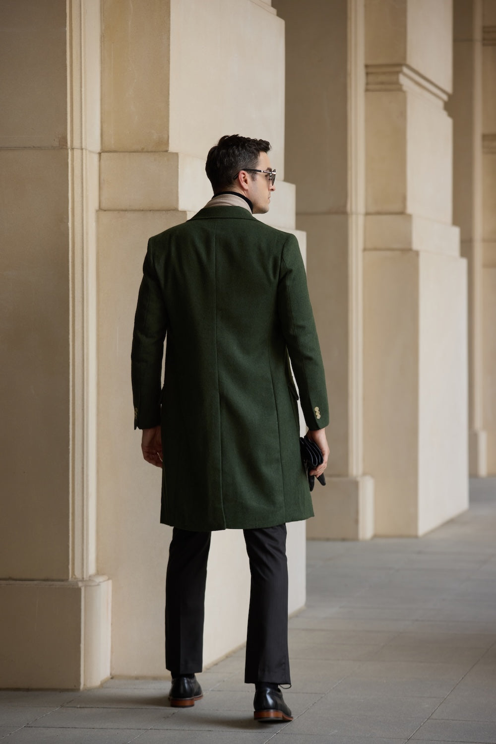 Rear view of green men’s long wool coat – elegant winter layering piece