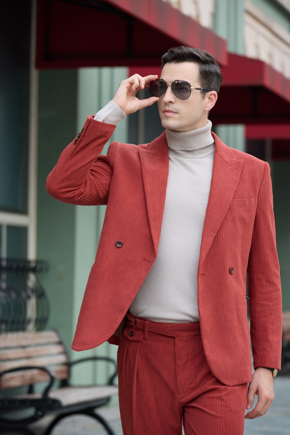 Upper body close-up of red corduroy suit – peak lapel and double-breasted detail