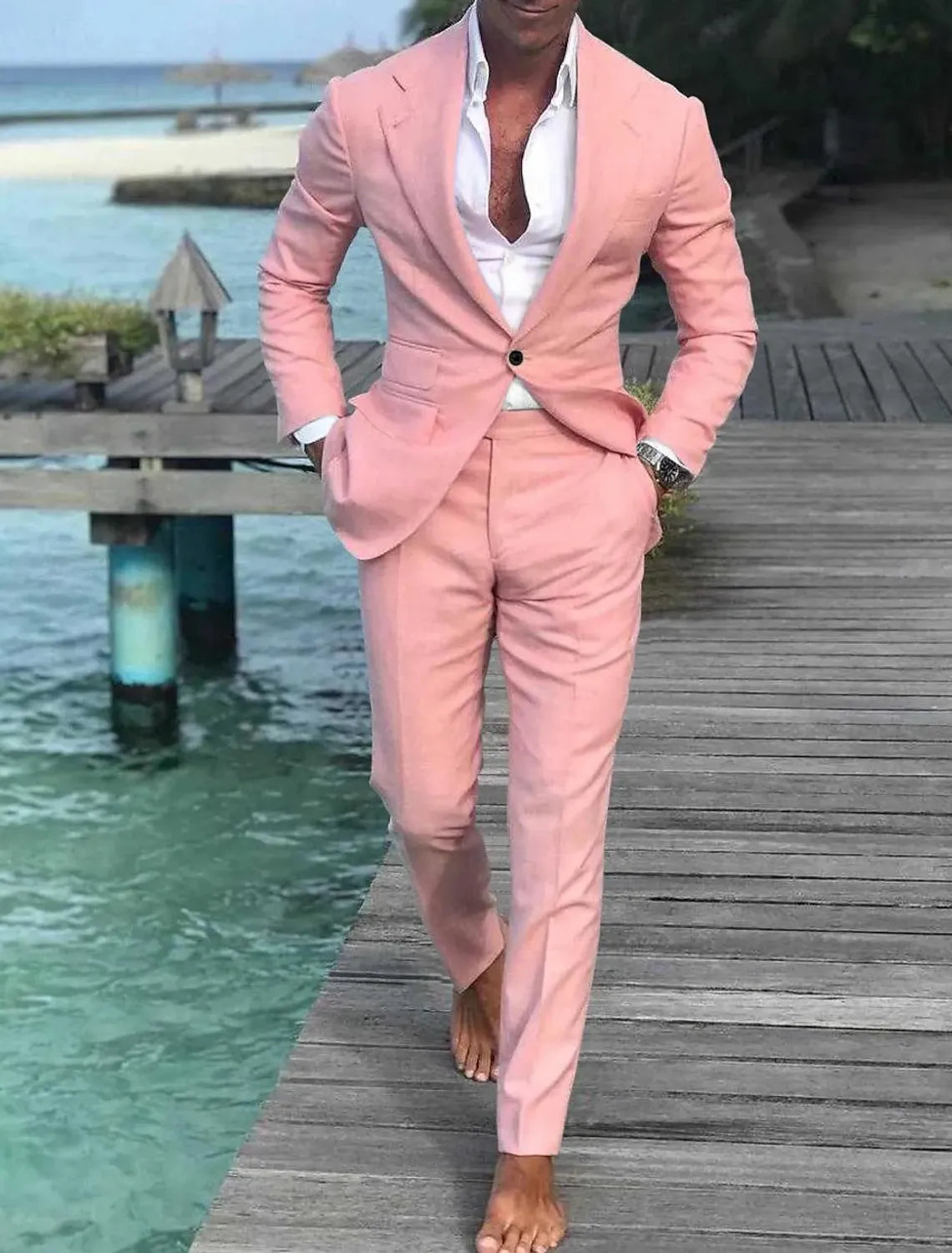 Full view of men's pink linen single breasted wedding suit – summer groom outfit on dock