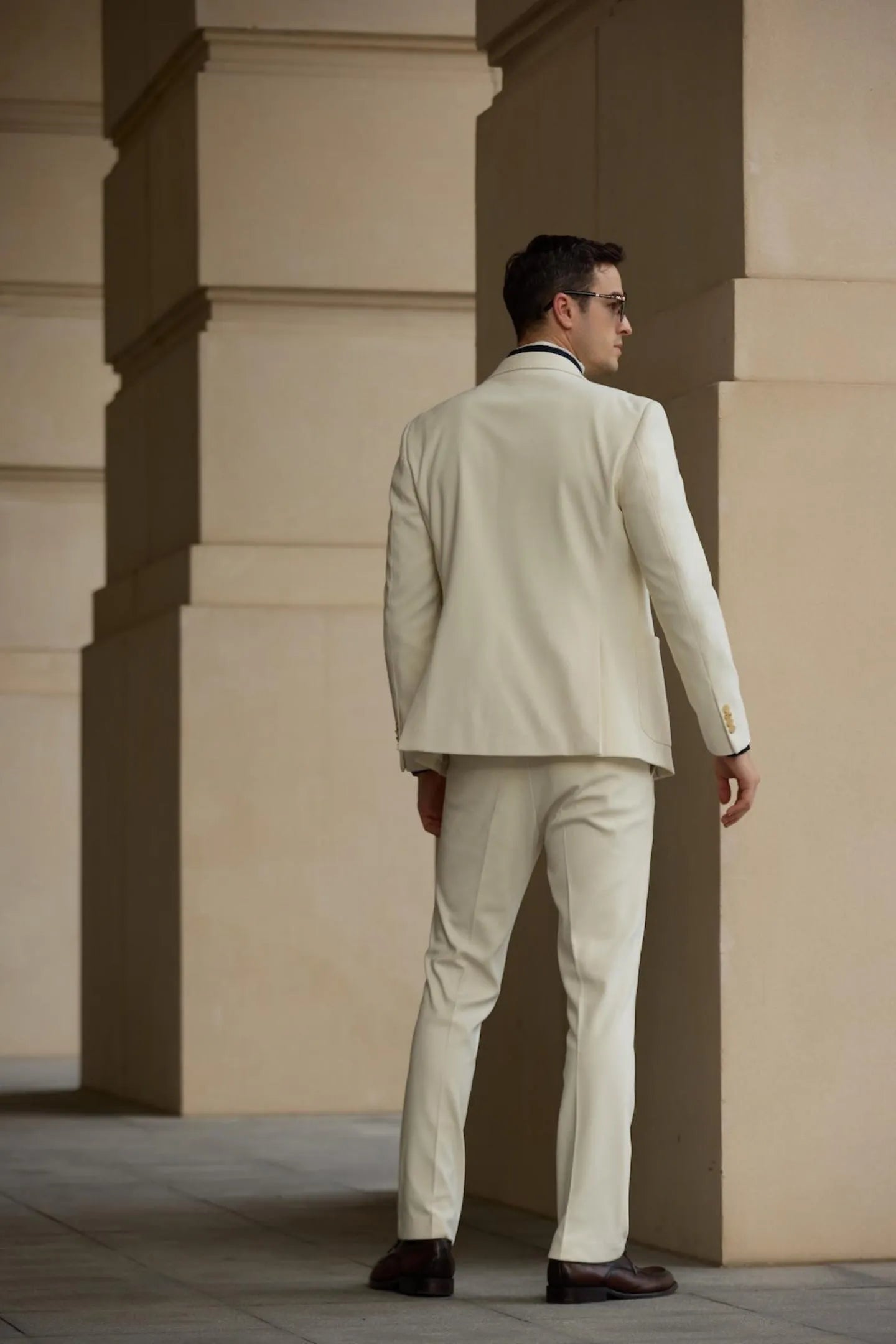 Back view of men's white herringbone tweed 2 piece suit with fitted blazer and slim trousers