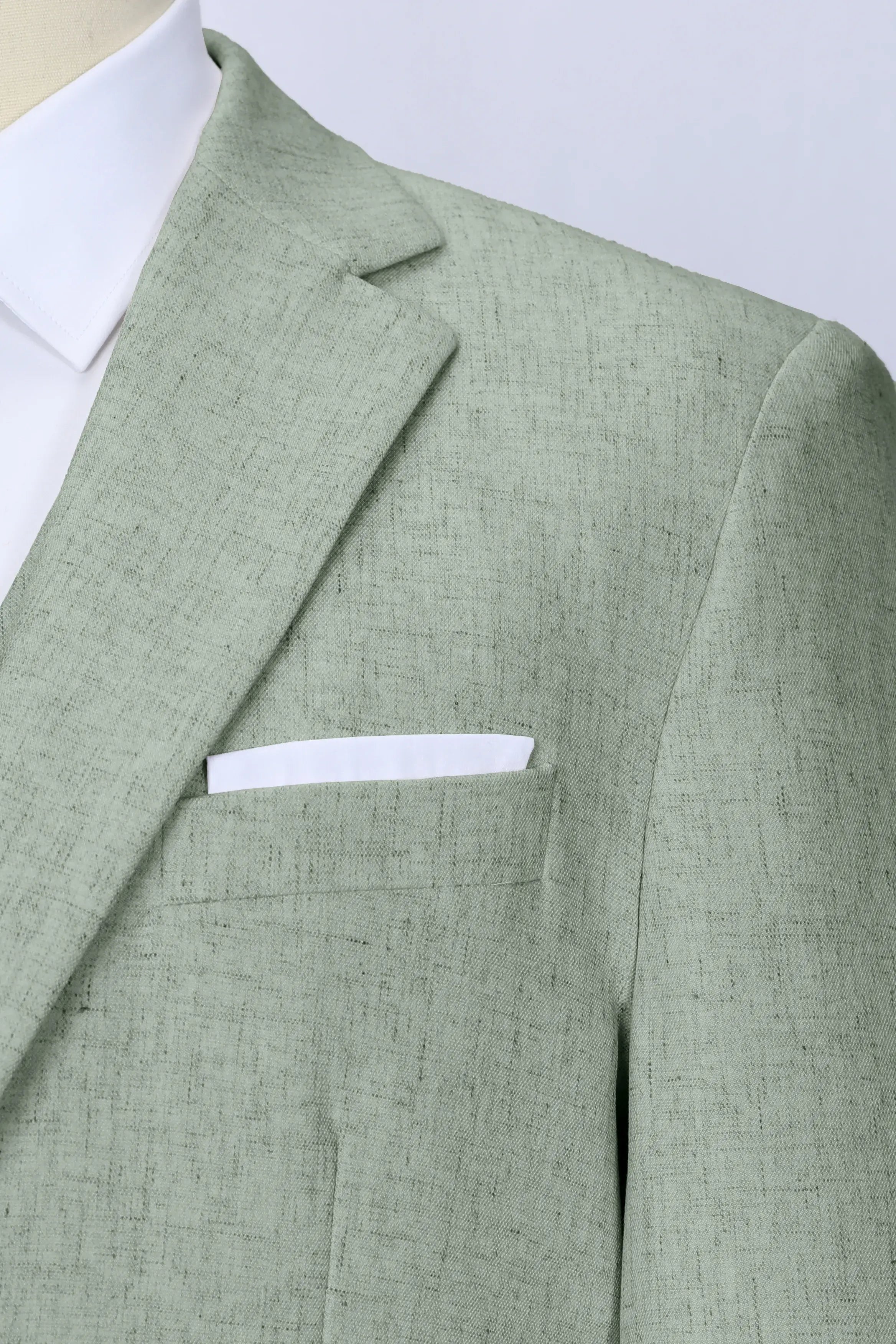 Lapel detail of light green linen blazer – breathable texture for warm-weather dressing
