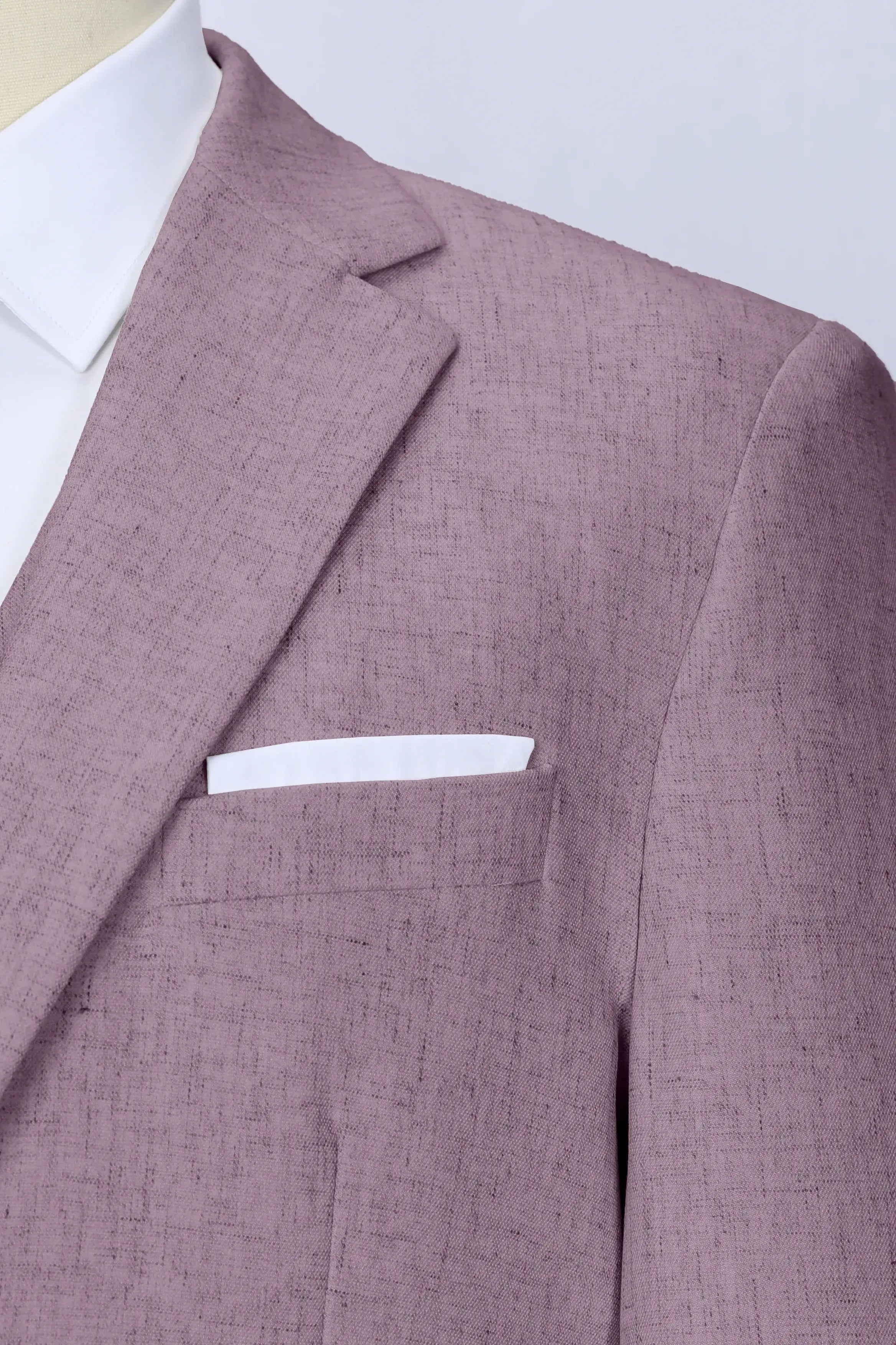 Close-up of purple linen blazer lapel and pocket square – textured fabric detail