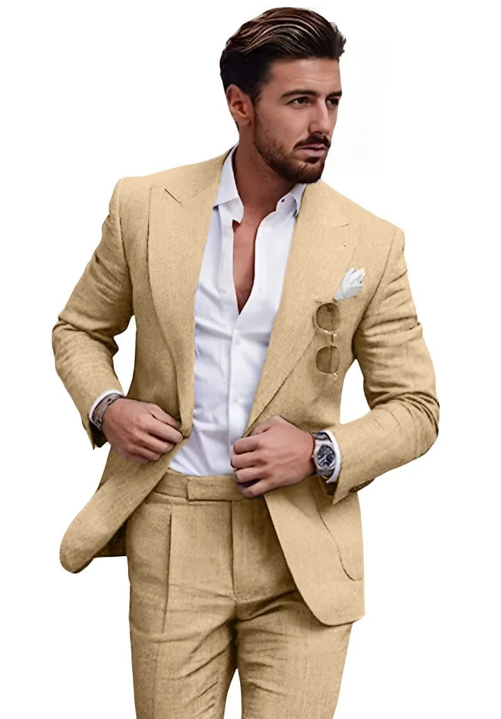 Man wearing champagne slim fit linen 2 piece summer suit with peaked lapel blazer and trousers, styled for wedding or casual summer wear.
