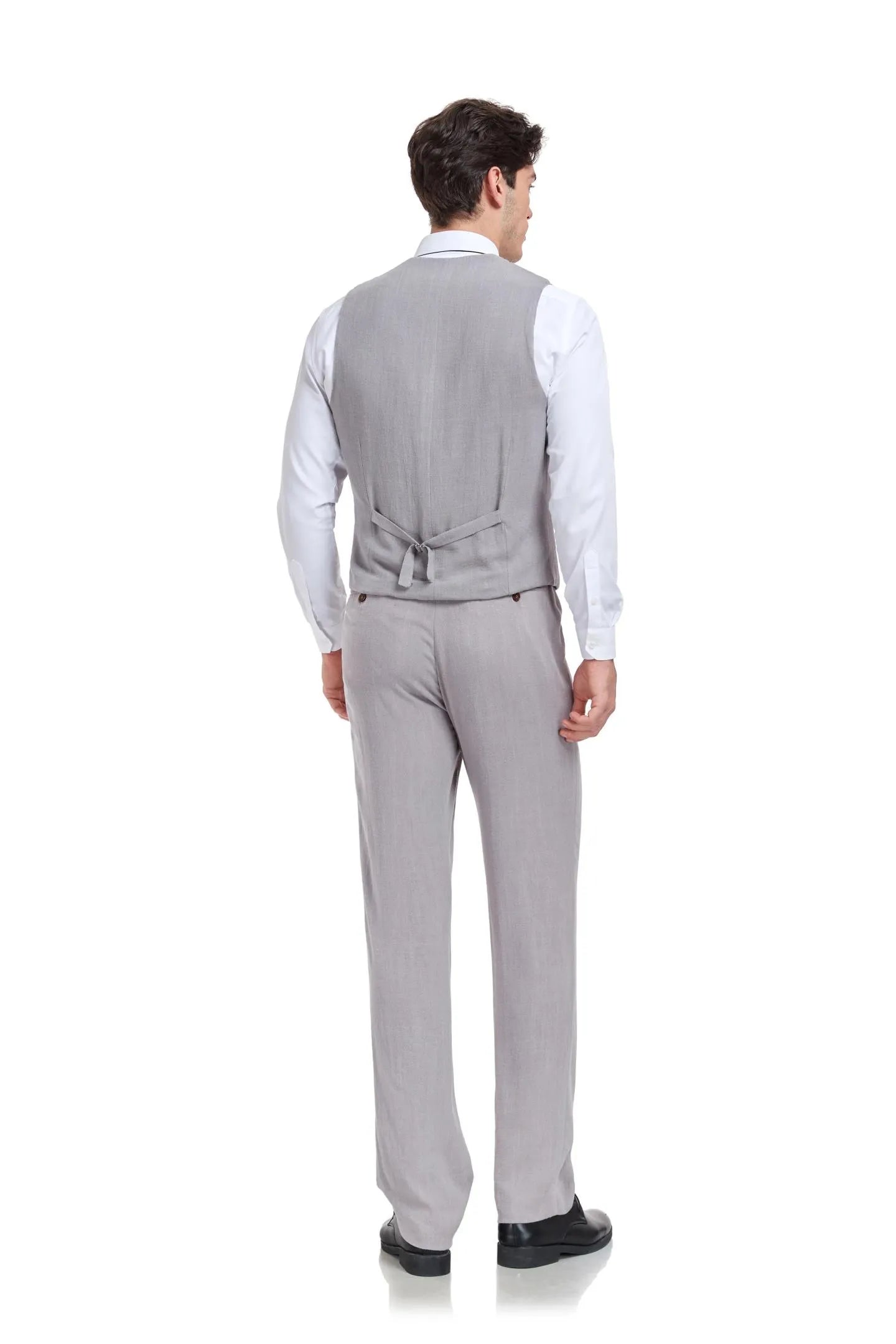 Back view of man in slim fit grey linen 2 piece suit with V-neck vest and trousers, styled for lightweight summer wear.