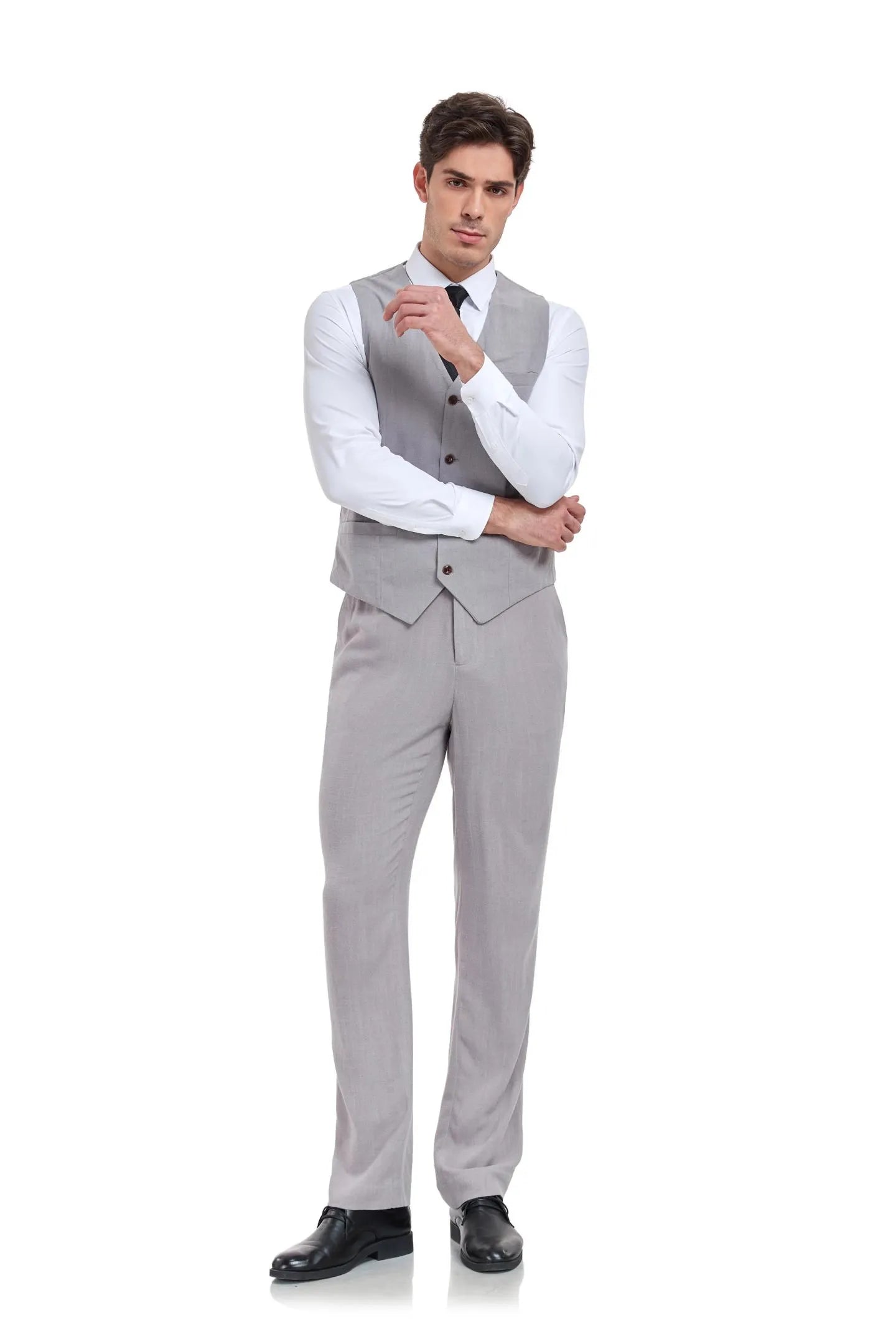 Man in slim fit grey linen 2 piece suit with vest and trousers, arms crossed, styled for summer weddings or casual events.